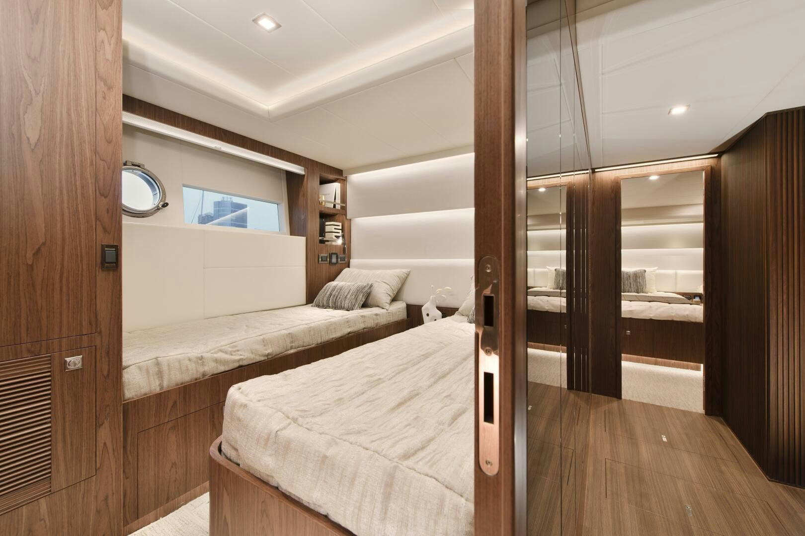a room with a bed and a mirror aboard V77S 610 Yacht for Sale