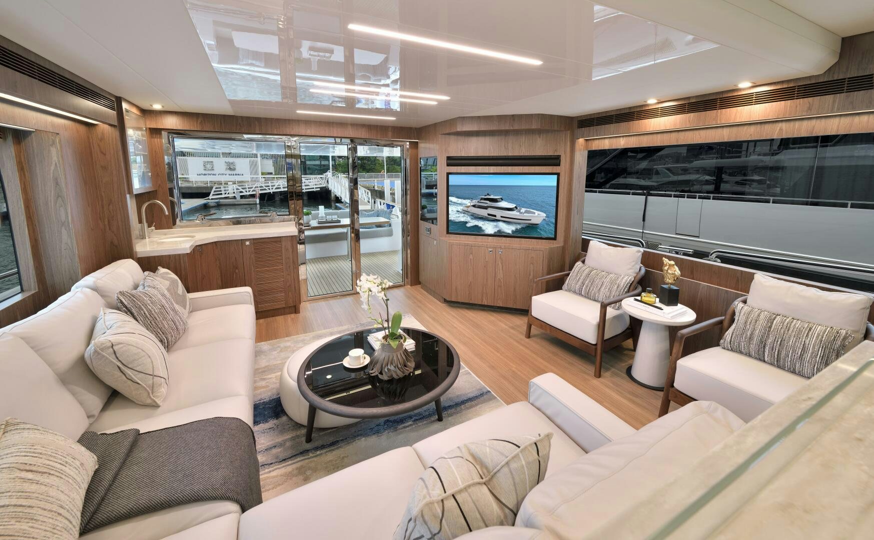 a living room with a large screen aboard V77S 610 Yacht for Sale