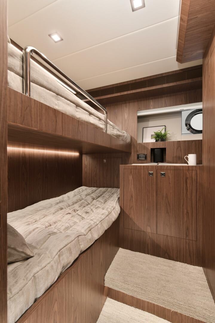 a room with a bed and a mirror aboard V77S 610 Yacht for Sale