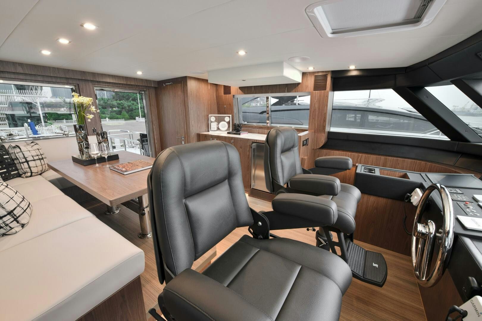 a room with a table chairs and a window aboard V77S 610 Yacht for Sale