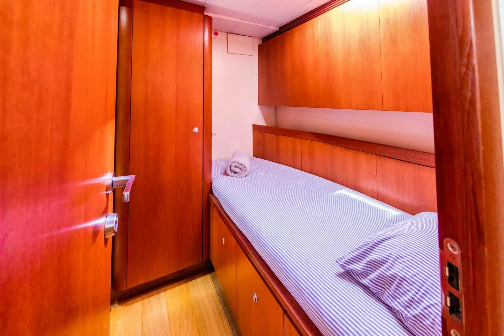 a room with a bed and a closet aboard HOPPETOSSE Yacht for Sale