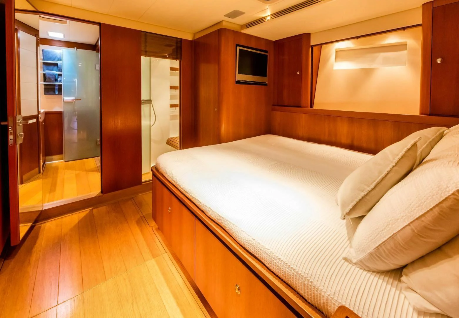 a room with a bed and a television aboard HOPPETOSSE Yacht for Sale