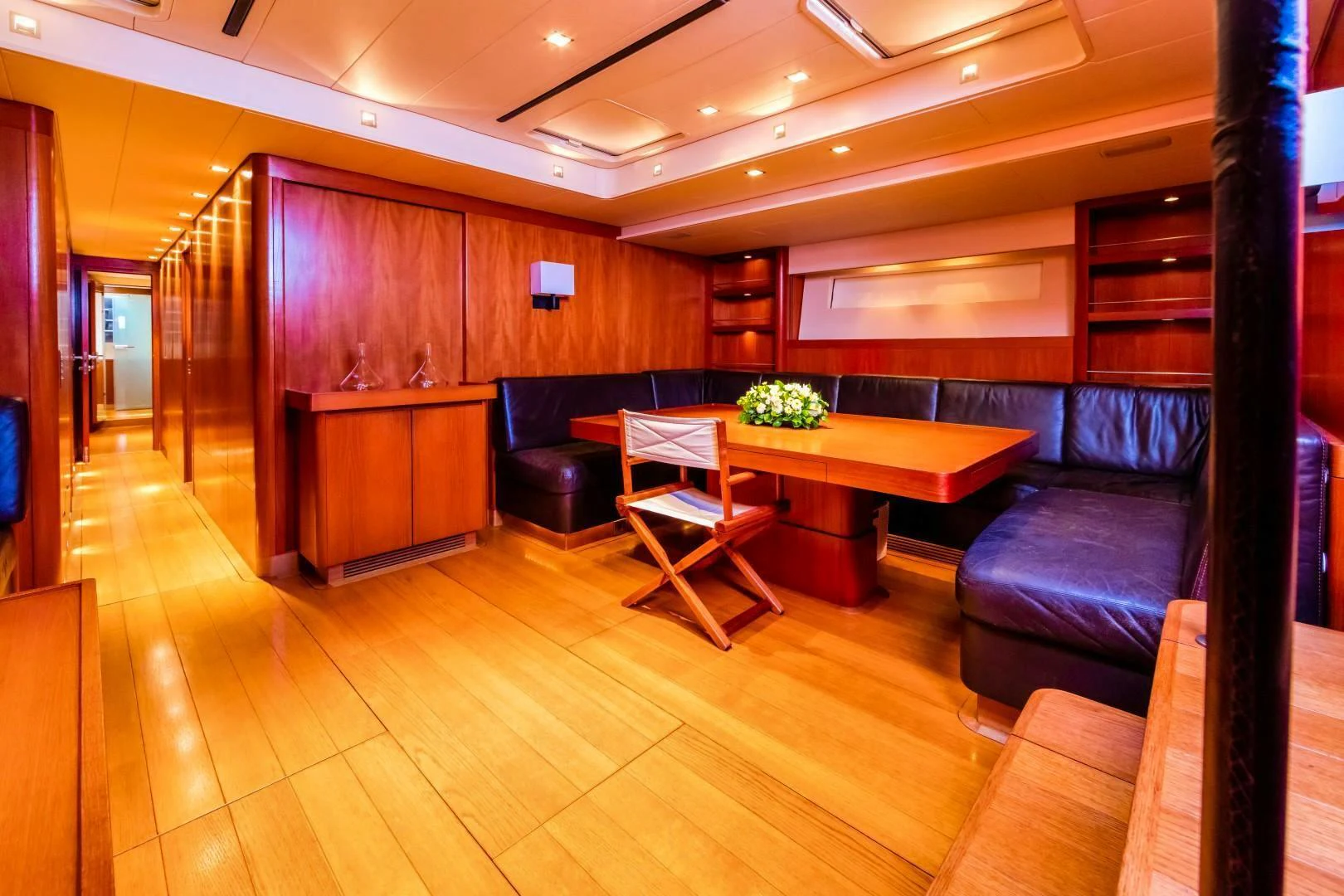 a living room with a wood floor aboard HOPPETOSSE Yacht for Sale