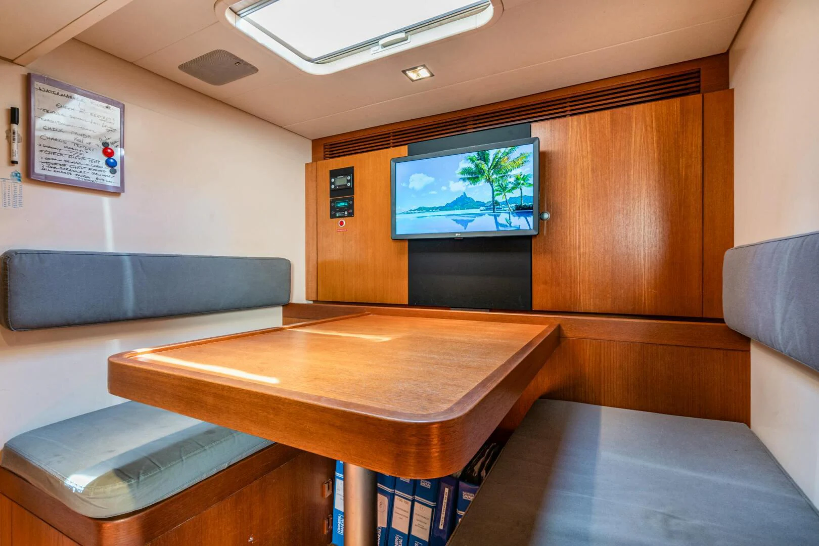 a room with a table and tv aboard HOPPETOSSE Yacht for Sale
