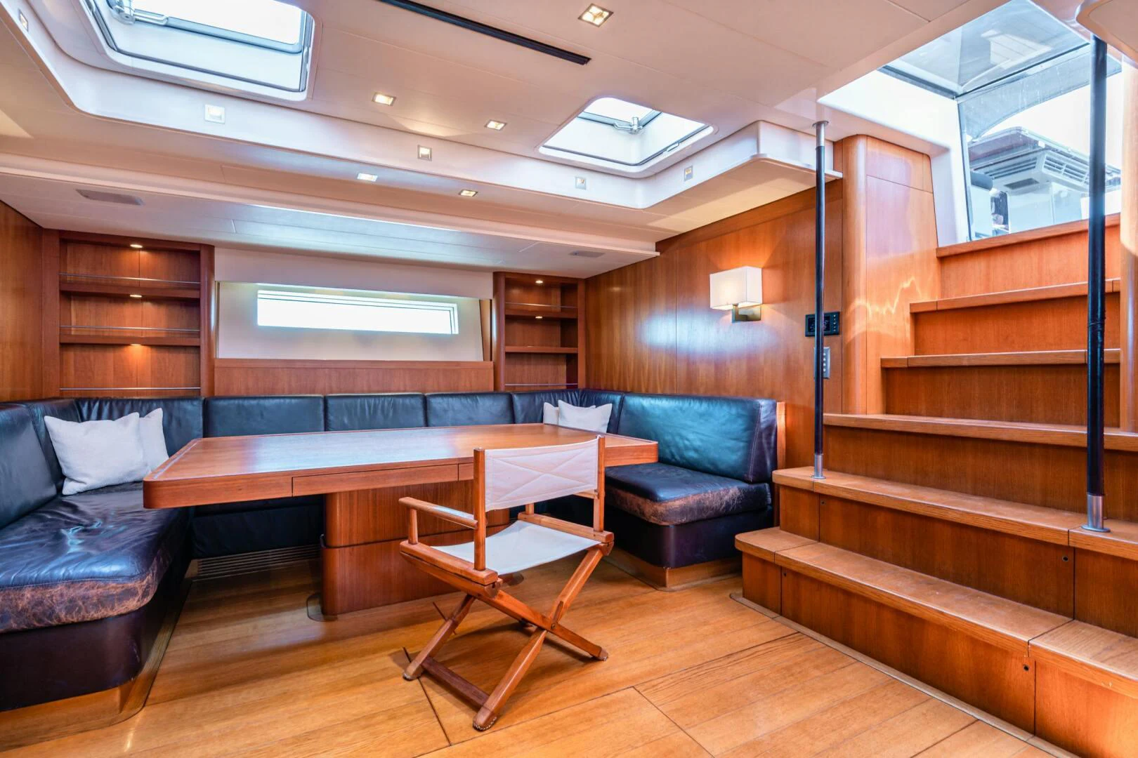 a room with a table and chairs aboard HOPPETOSSE Yacht for Sale