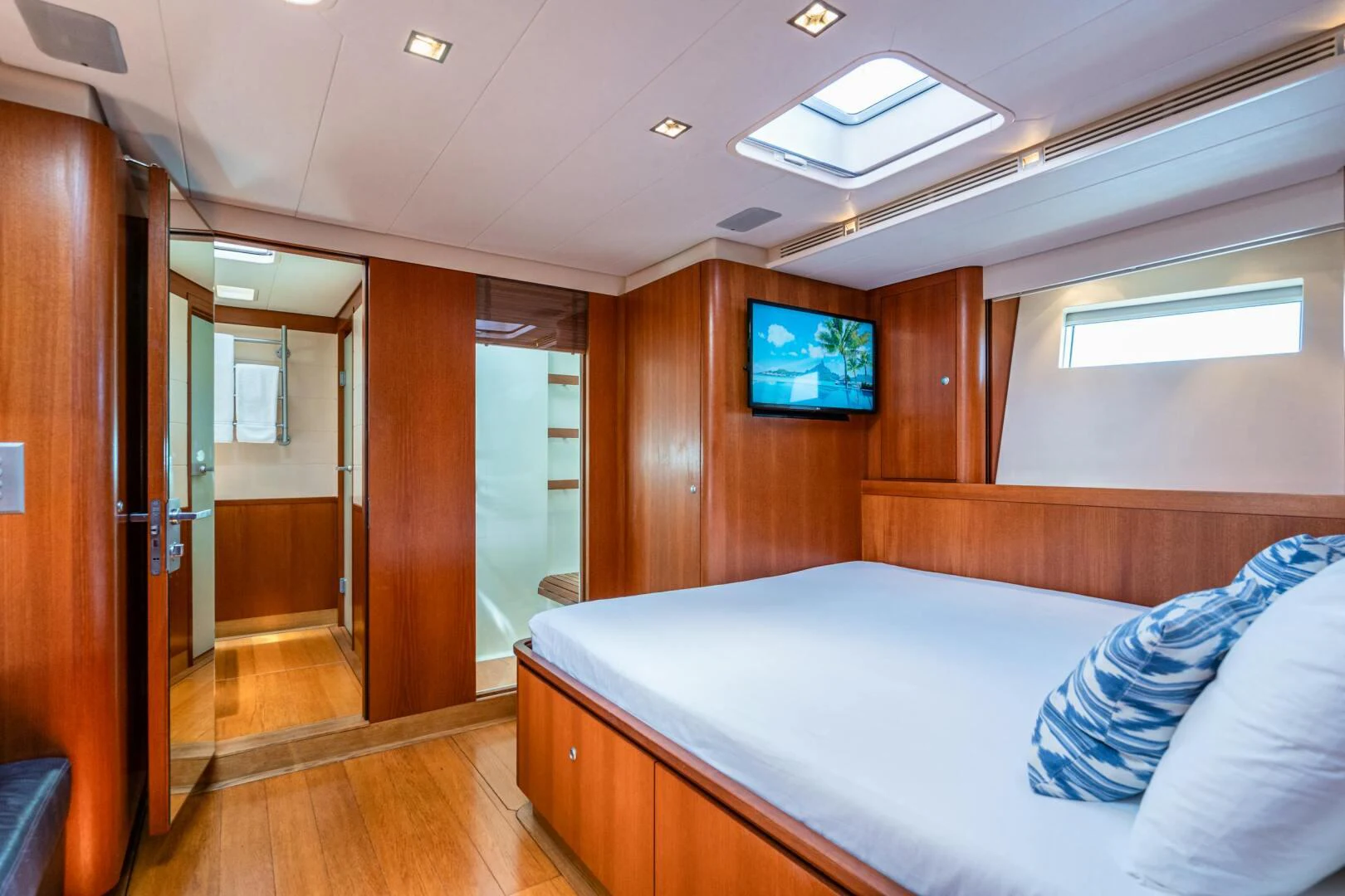a room with a bed and a tv on the wall aboard HOPPETOSSE Yacht for Sale
