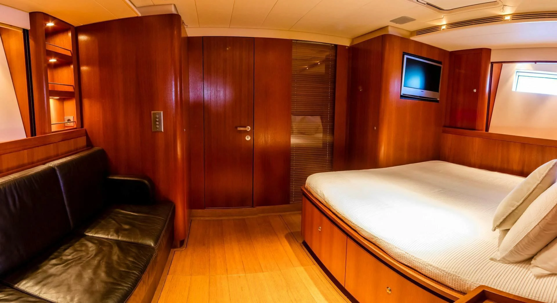 a room with a bed and a television aboard HOPPETOSSE Yacht for Sale