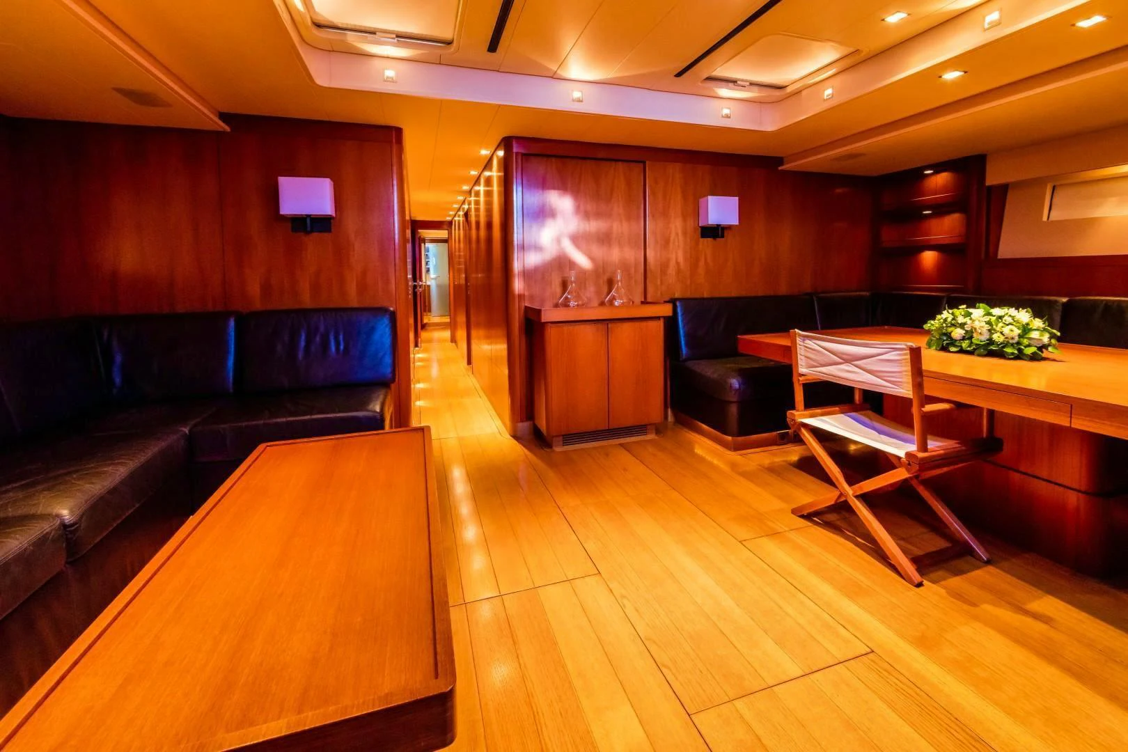 a room with a couch and a table aboard HOPPETOSSE Yacht for Sale