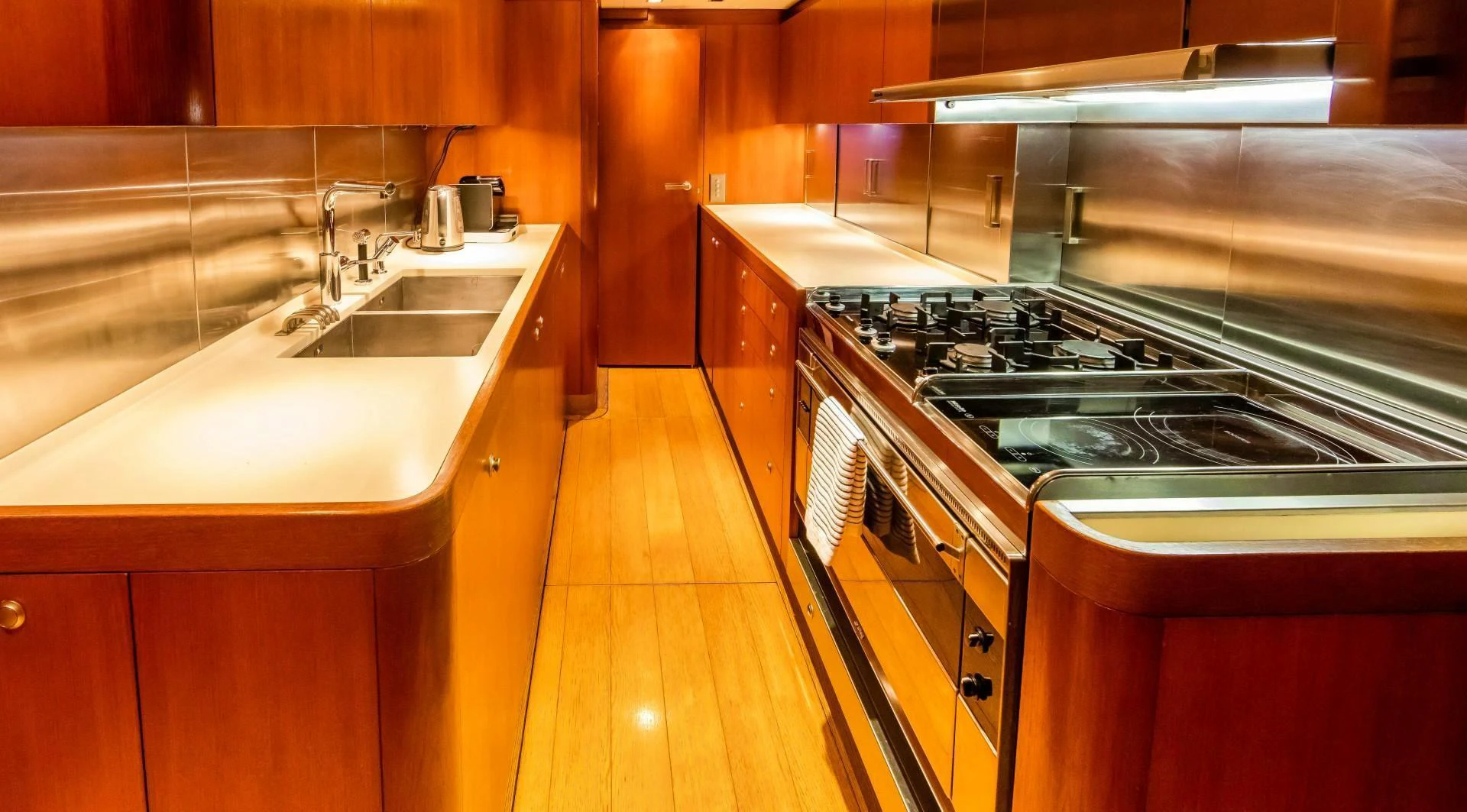 a kitchen with a stove and sink aboard HOPPETOSSE Yacht for Sale