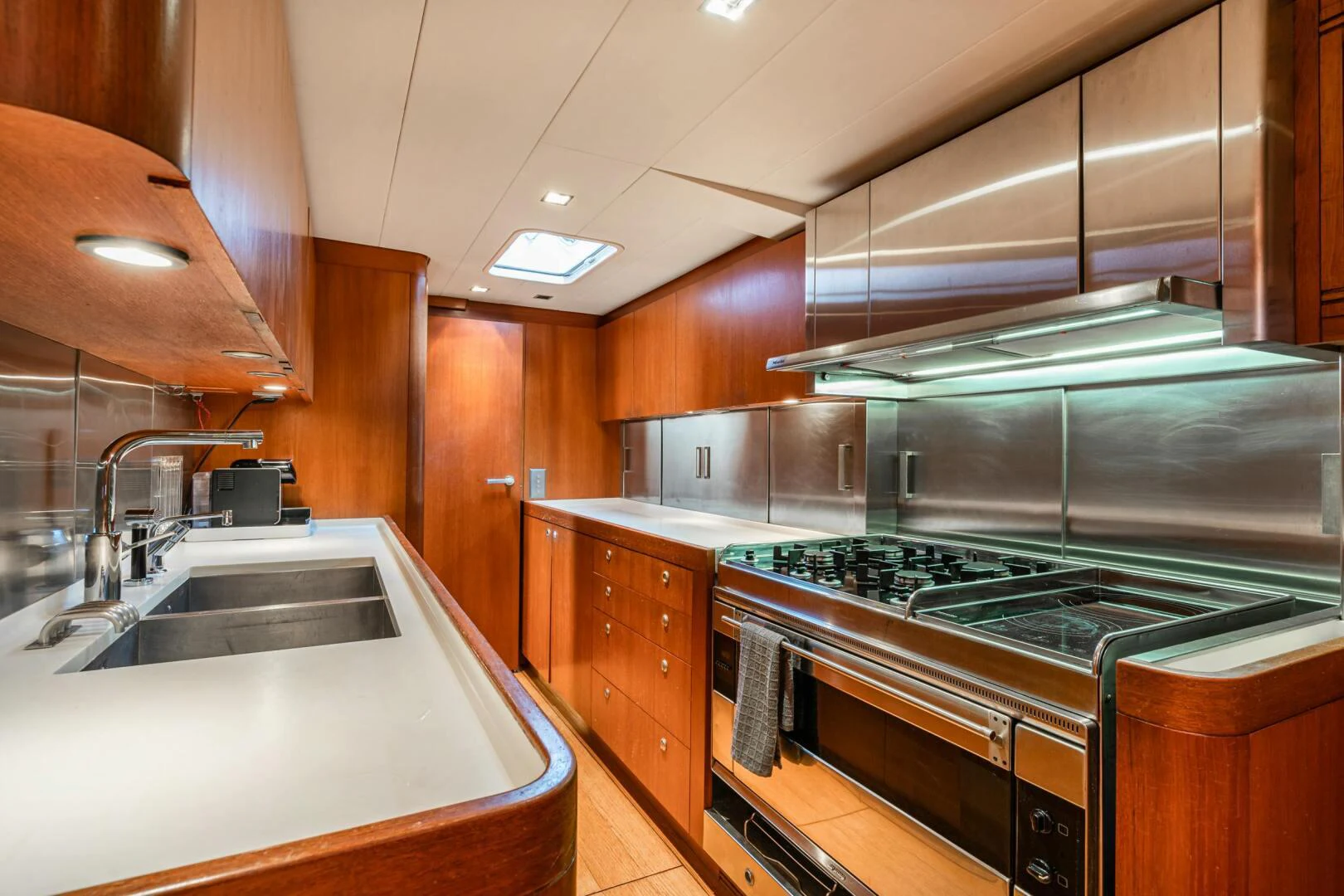 a kitchen with a stainless steel stove aboard HOPPETOSSE Yacht for Sale