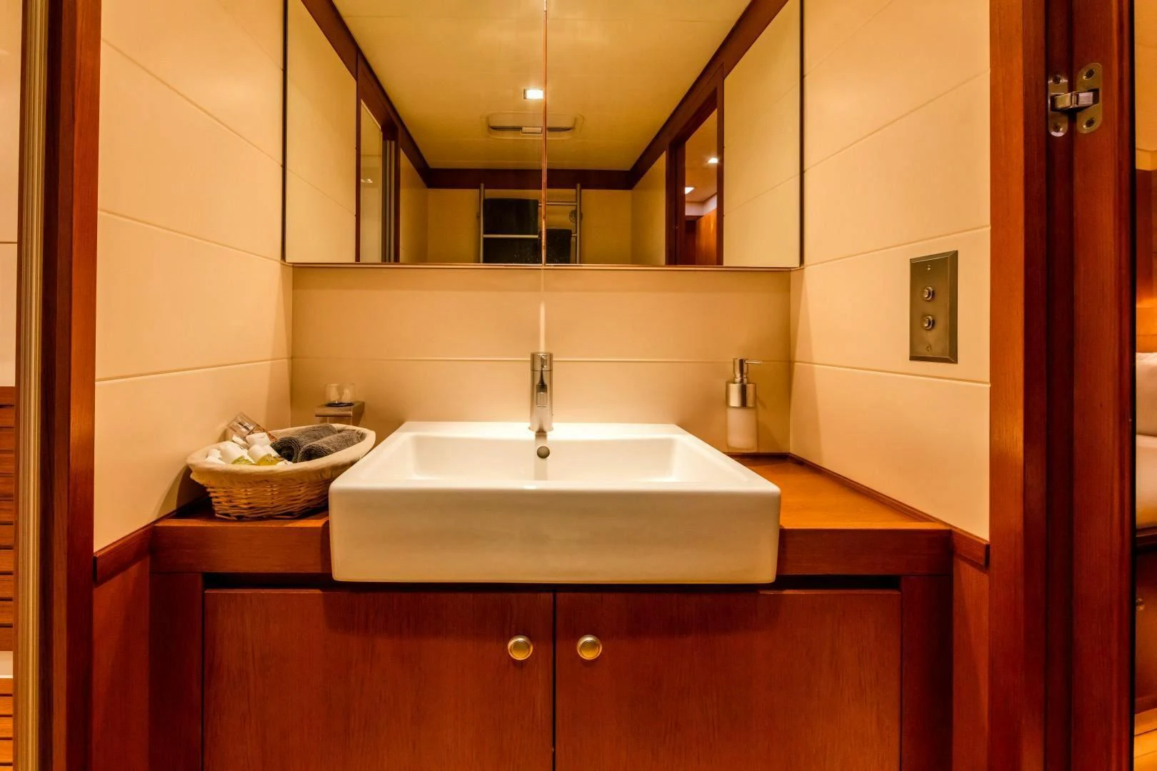 a bathroom with a sink and a mirror aboard HOPPETOSSE Yacht for Sale