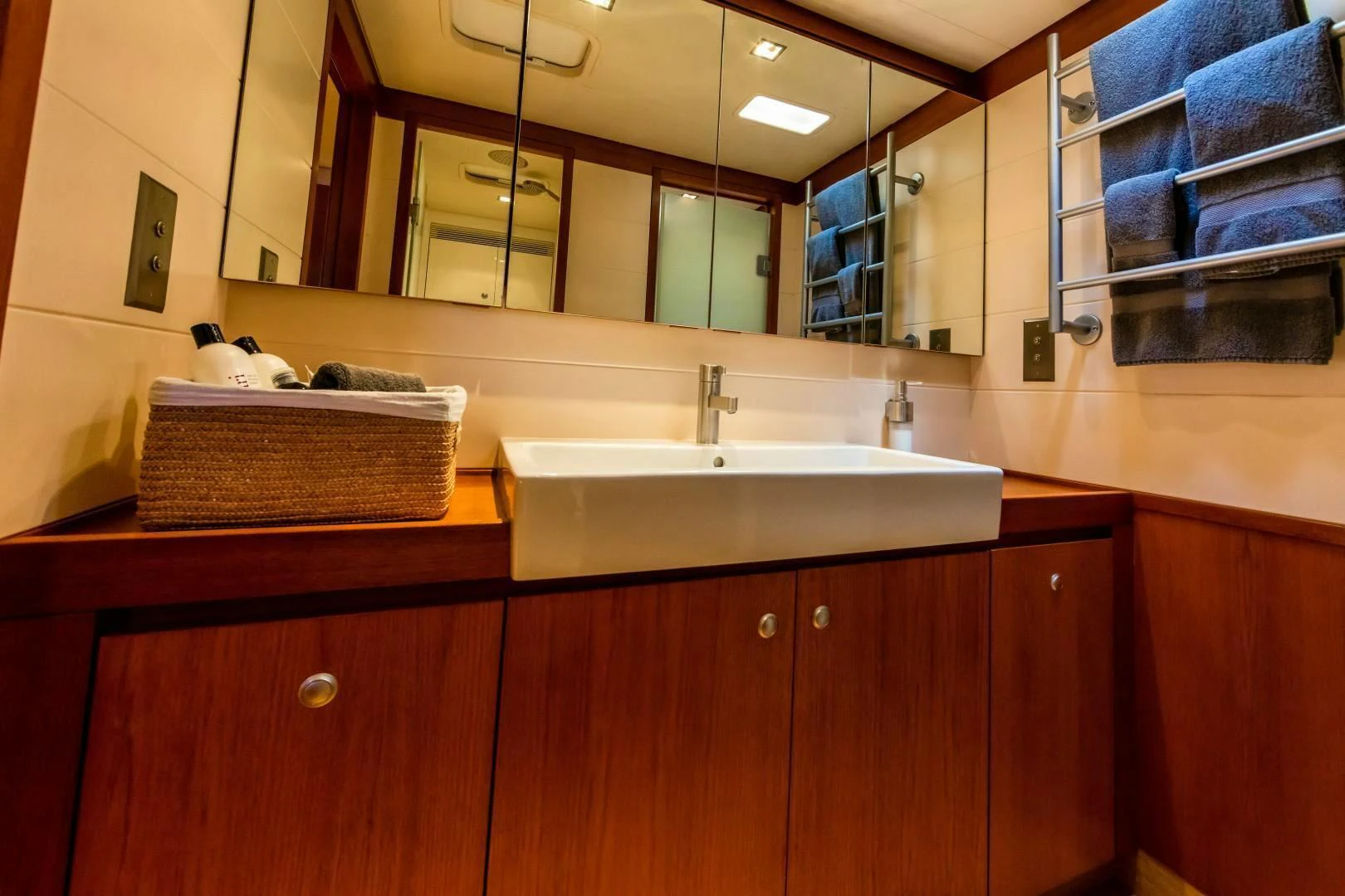 a bathroom with a sink and a mirror aboard HOPPETOSSE Yacht for Sale