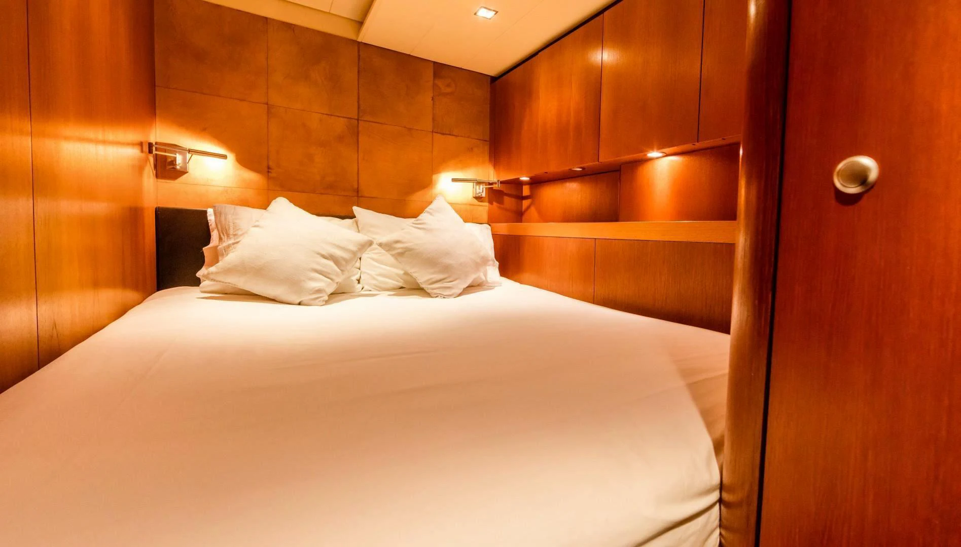 a bed with white sheets aboard HOPPETOSSE Yacht for Sale