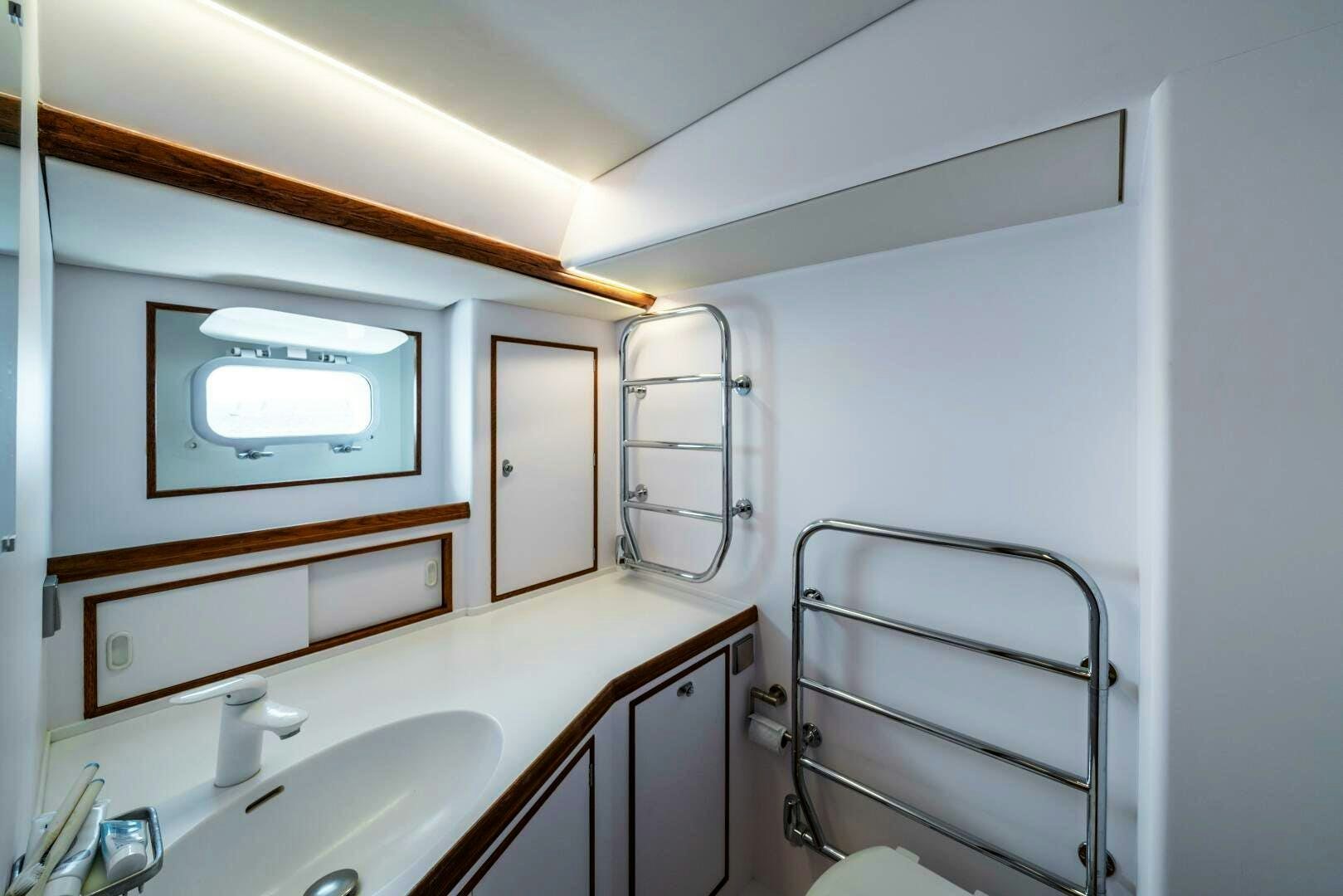 a room with a bed and a television aboard ALTAIR Yacht for Sale