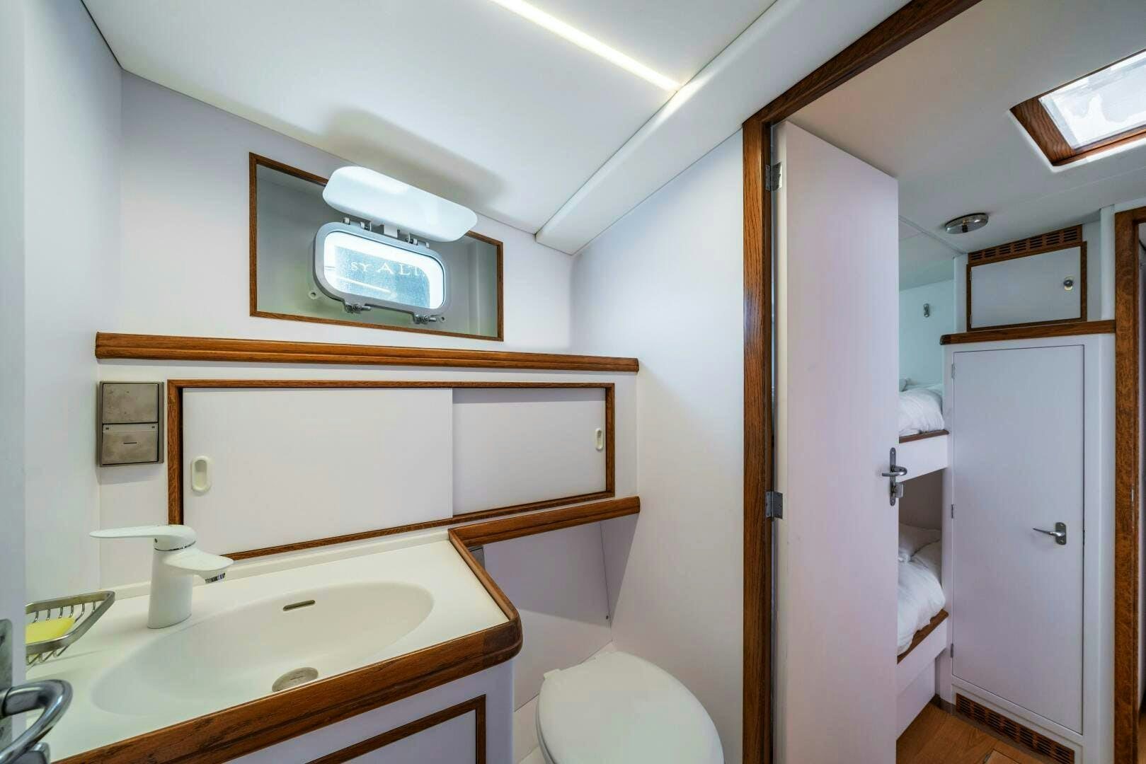 a bathroom with a sink and a microwave aboard ALTAIR Yacht for Sale