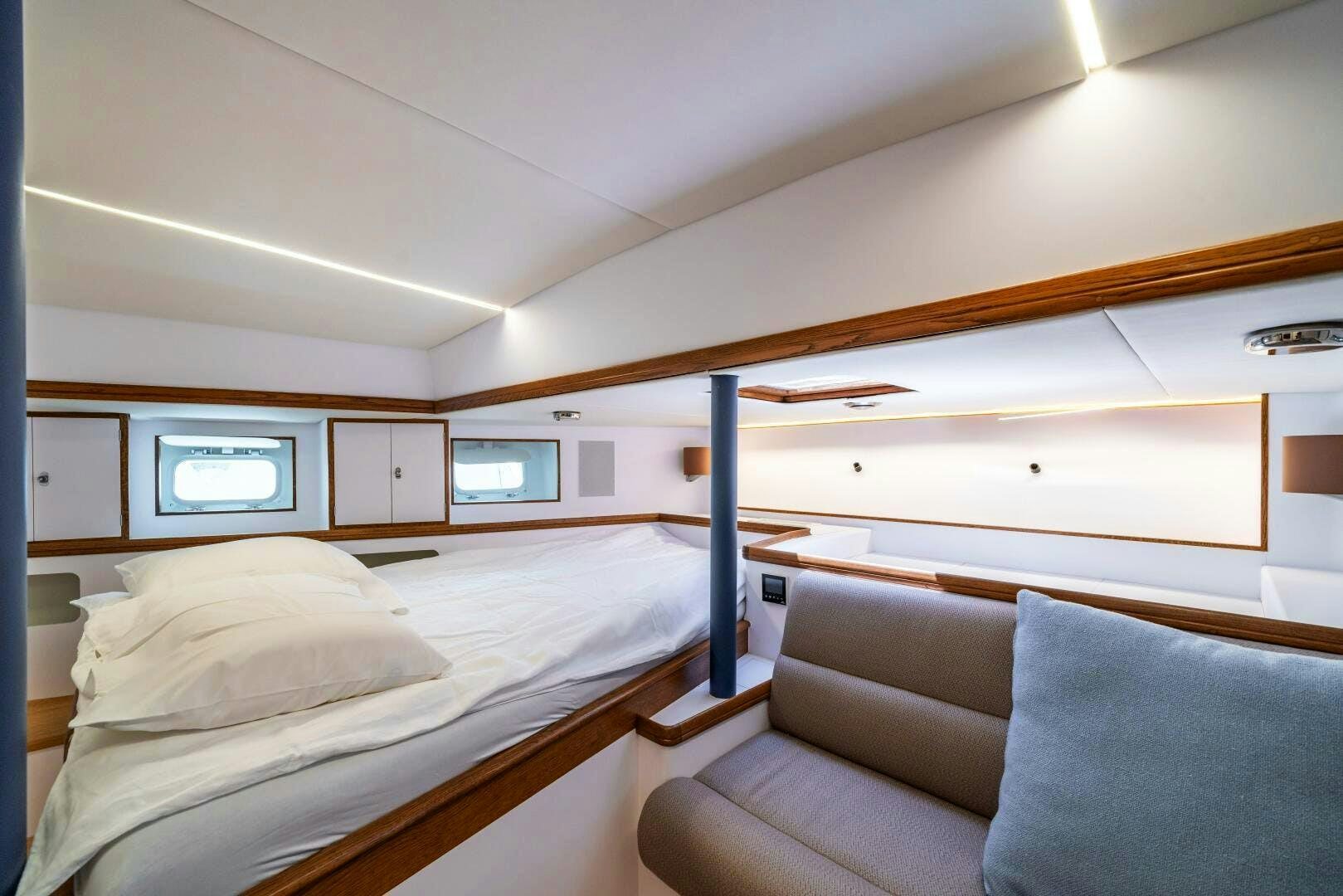 a room with a bed and a couch aboard ALTAIR Yacht for Sale