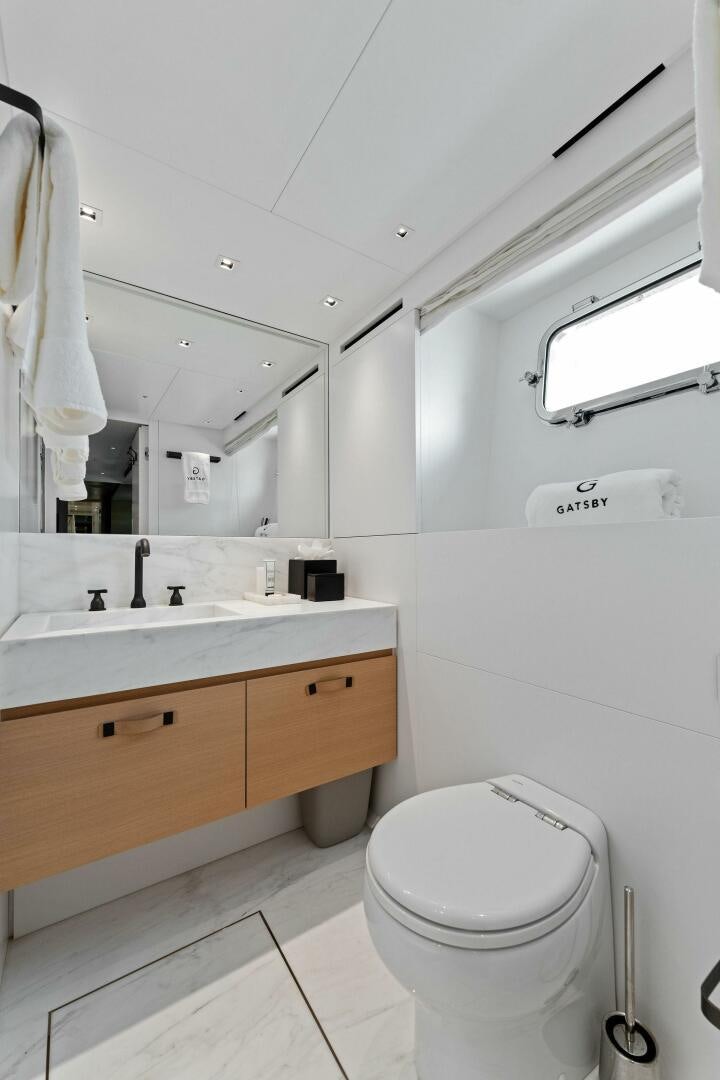 a bathroom with a toilet and a sink aboard GATSBY Yacht for Sale