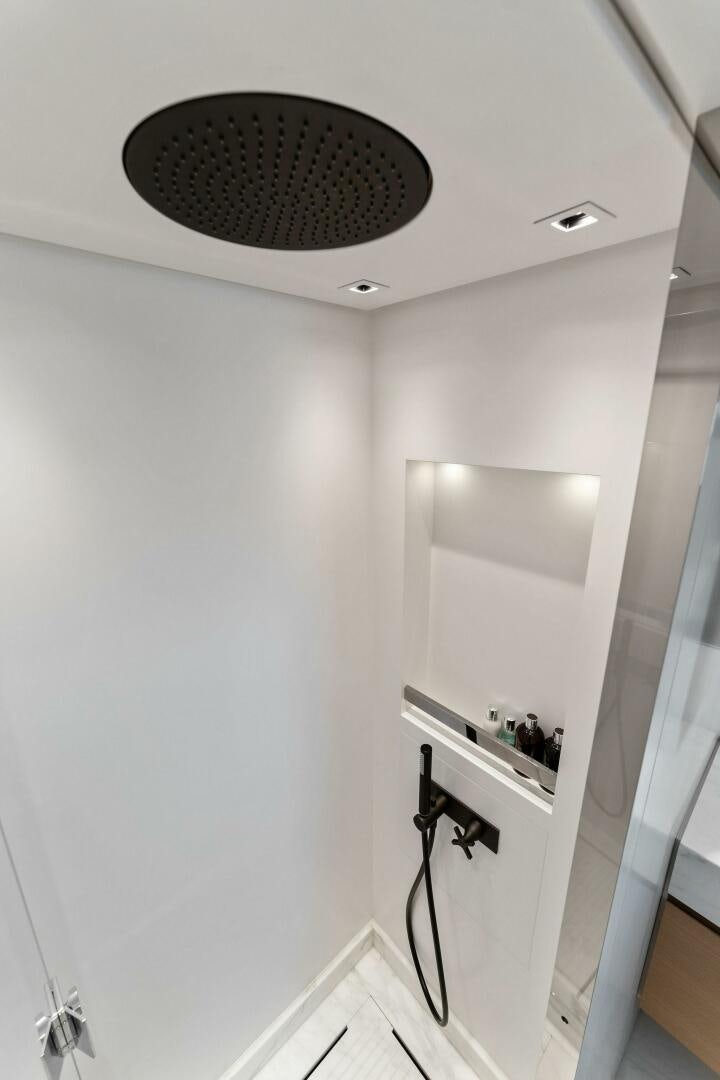 a bathroom with a round mirror aboard GATSBY Yacht for Sale