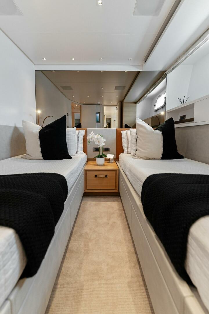 a bedroom with two beds aboard GATSBY Yacht for Sale