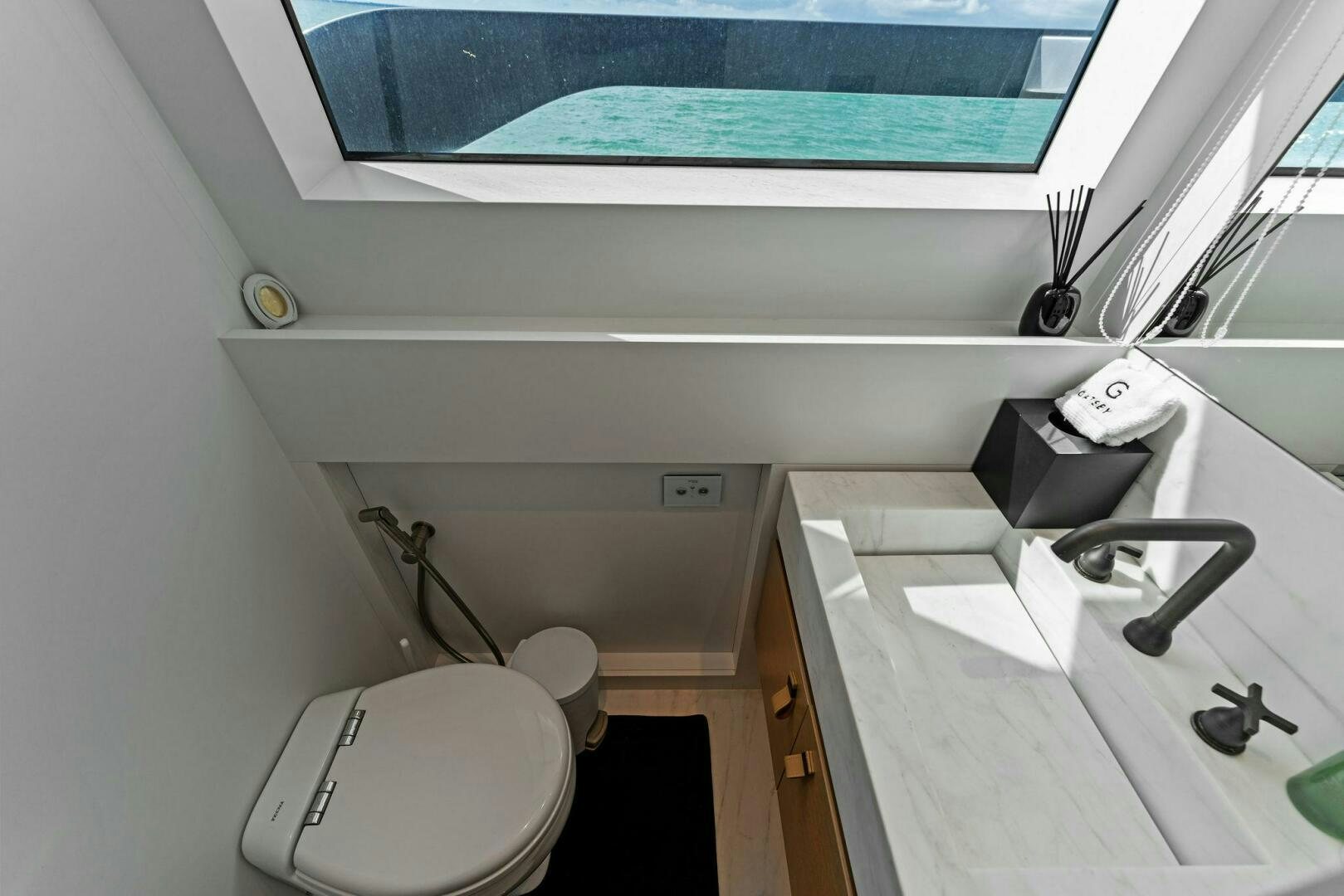 a bathroom with a sink and toilet aboard GATSBY Yacht for Sale