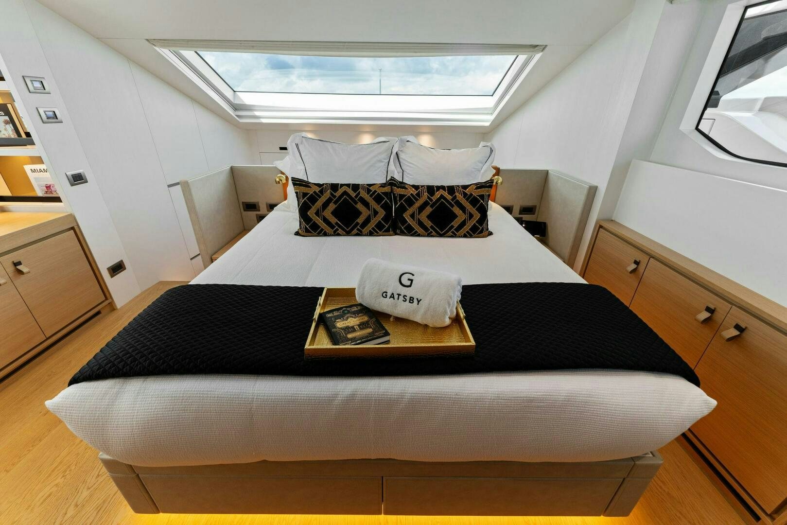 a bed with a black comforter aboard GATSBY Yacht for Sale
