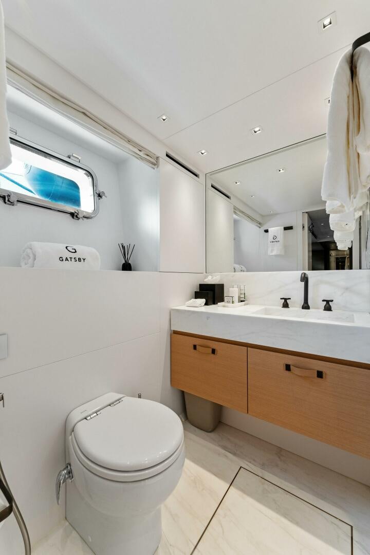 a bathroom with a toilet and a sink aboard GATSBY Yacht for Sale