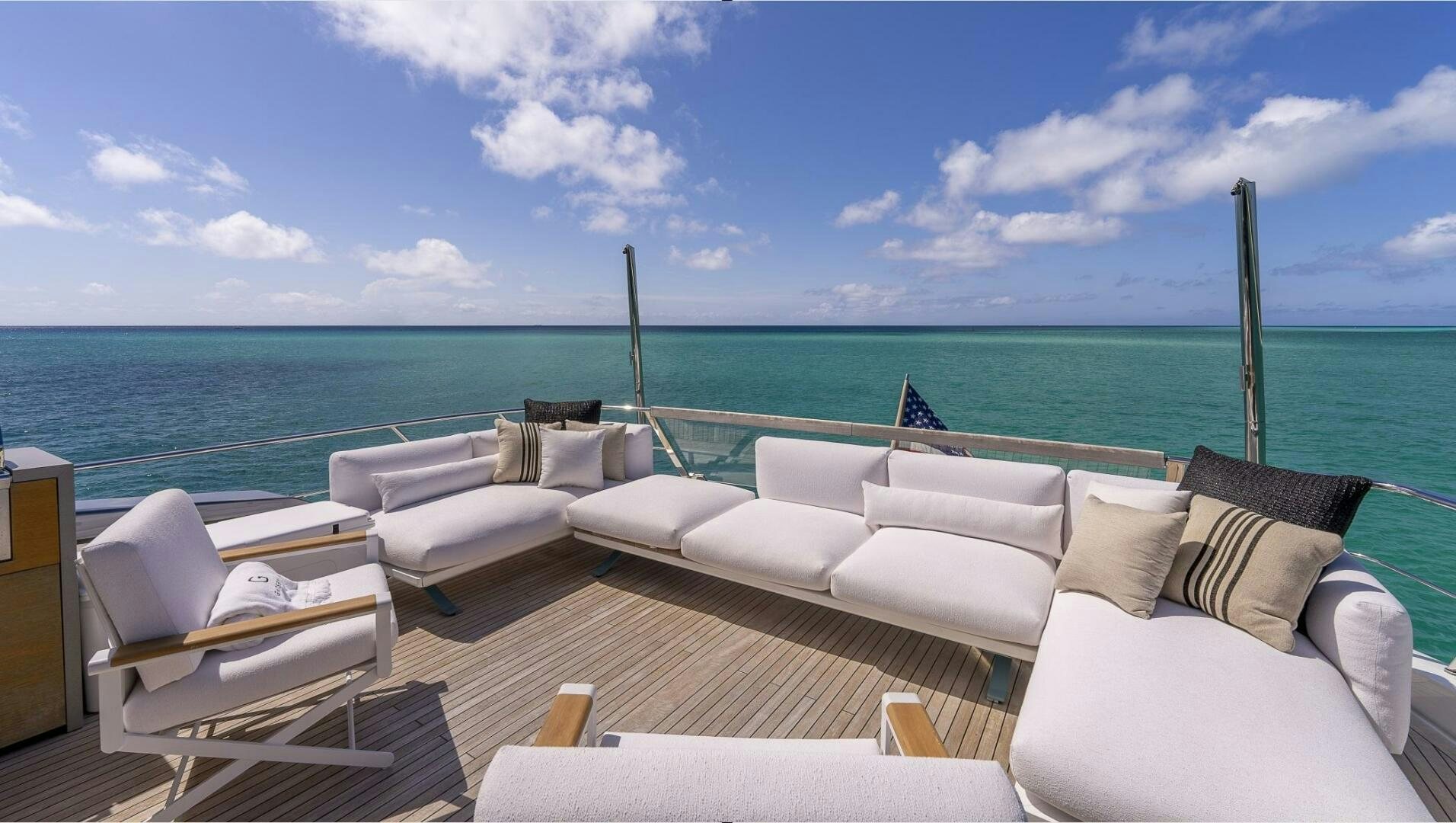 a room with a view of the ocean and a beach aboard GATSBY Yacht for Sale