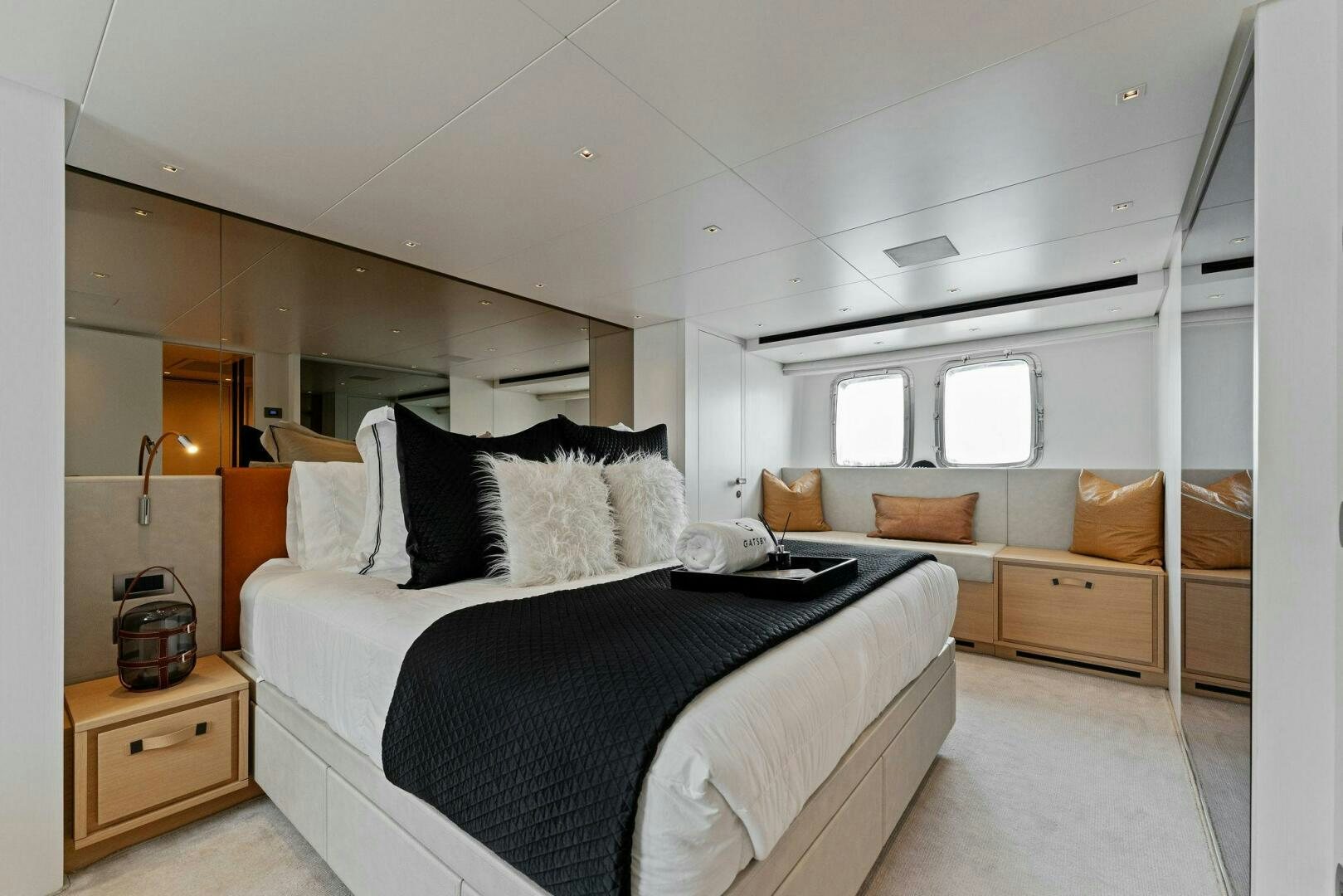 a bedroom with a bed and a couch aboard GATSBY Yacht for Sale
