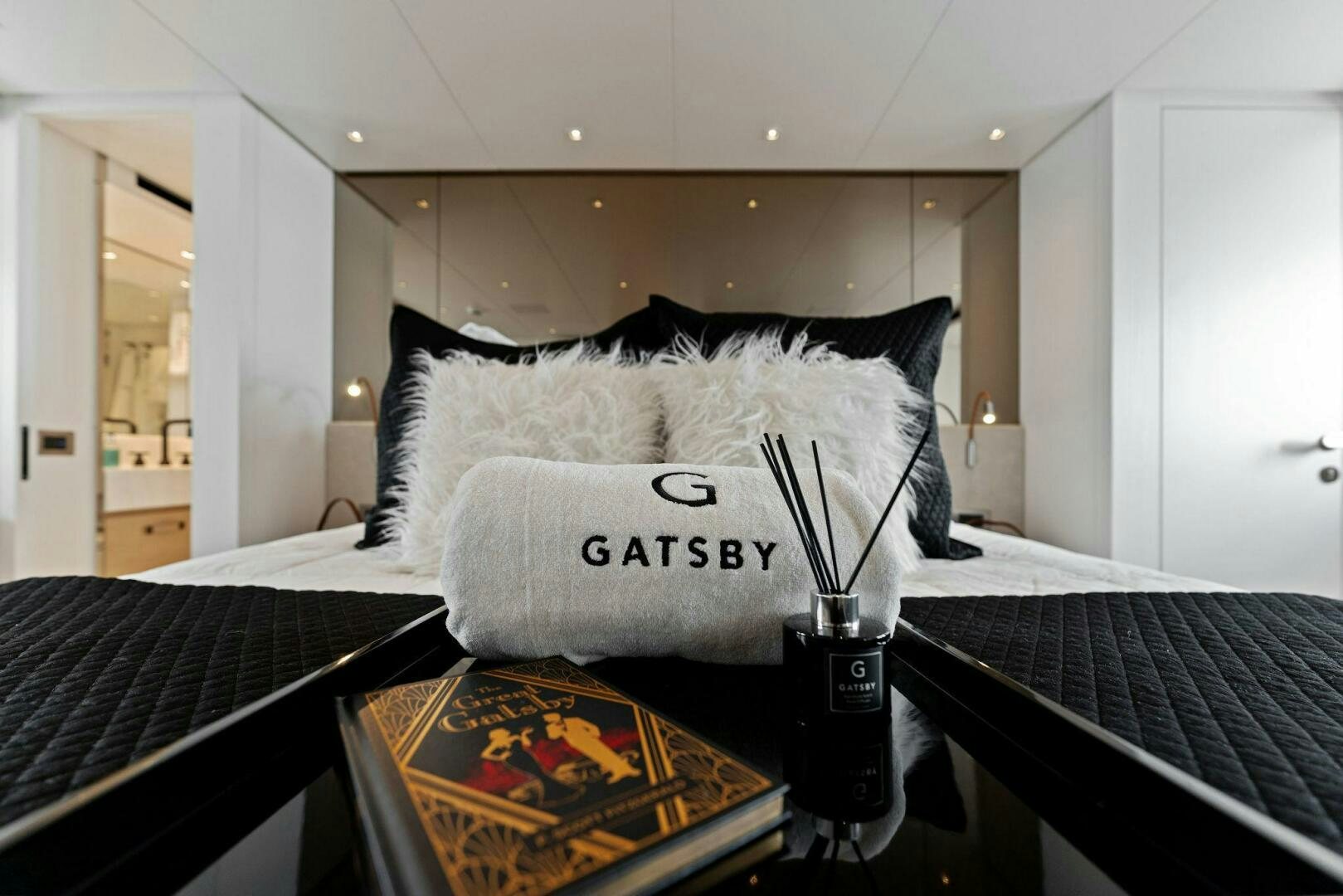 a bed with a pillow and a coffee maker on it aboard GATSBY Yacht for Sale