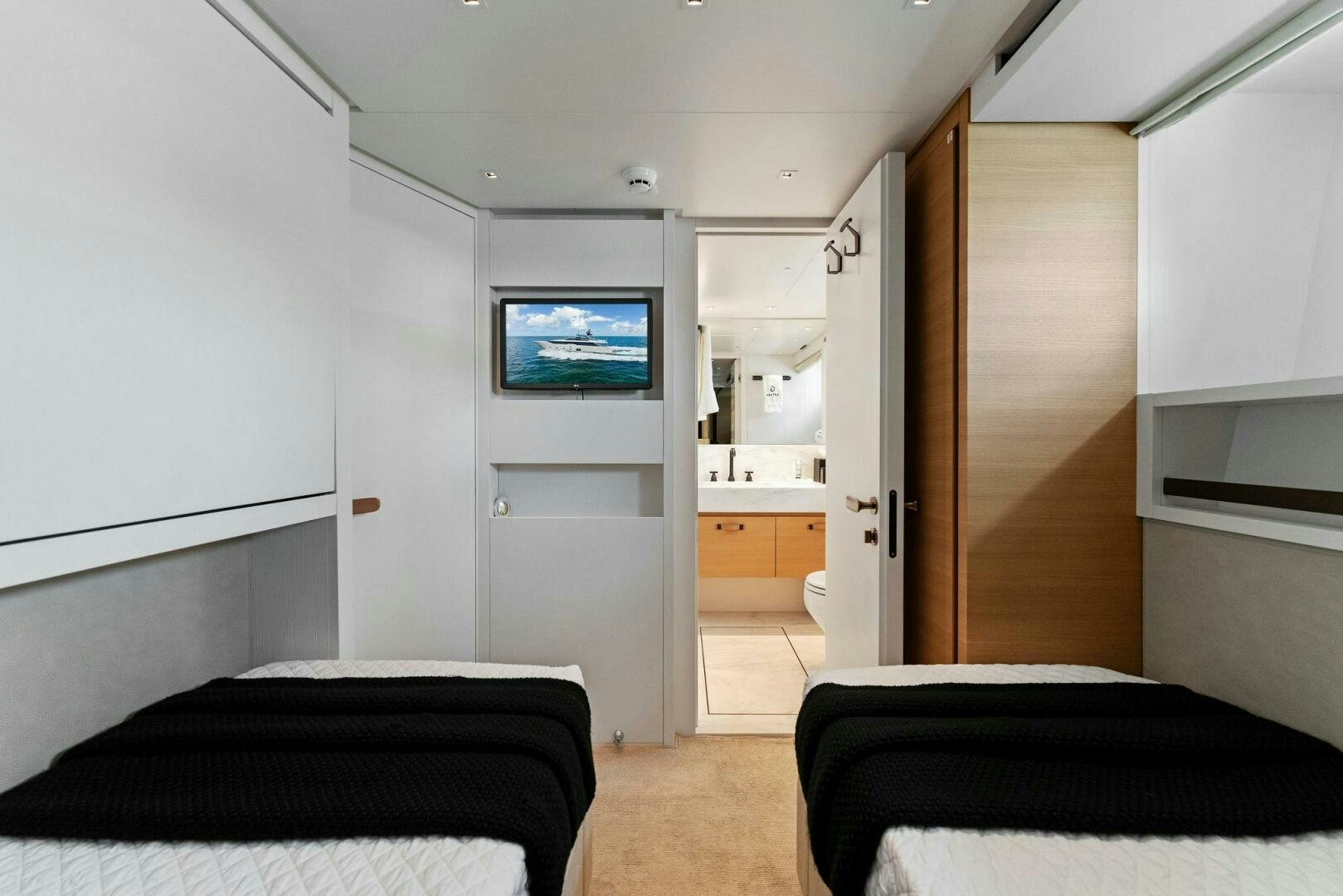 a bedroom with a tv on the wall aboard GATSBY Yacht for Sale