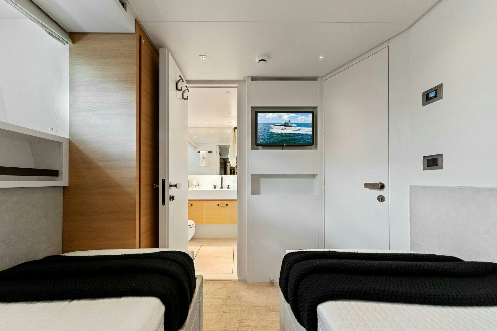 a bedroom with a tv aboard GATSBY Yacht for Sale