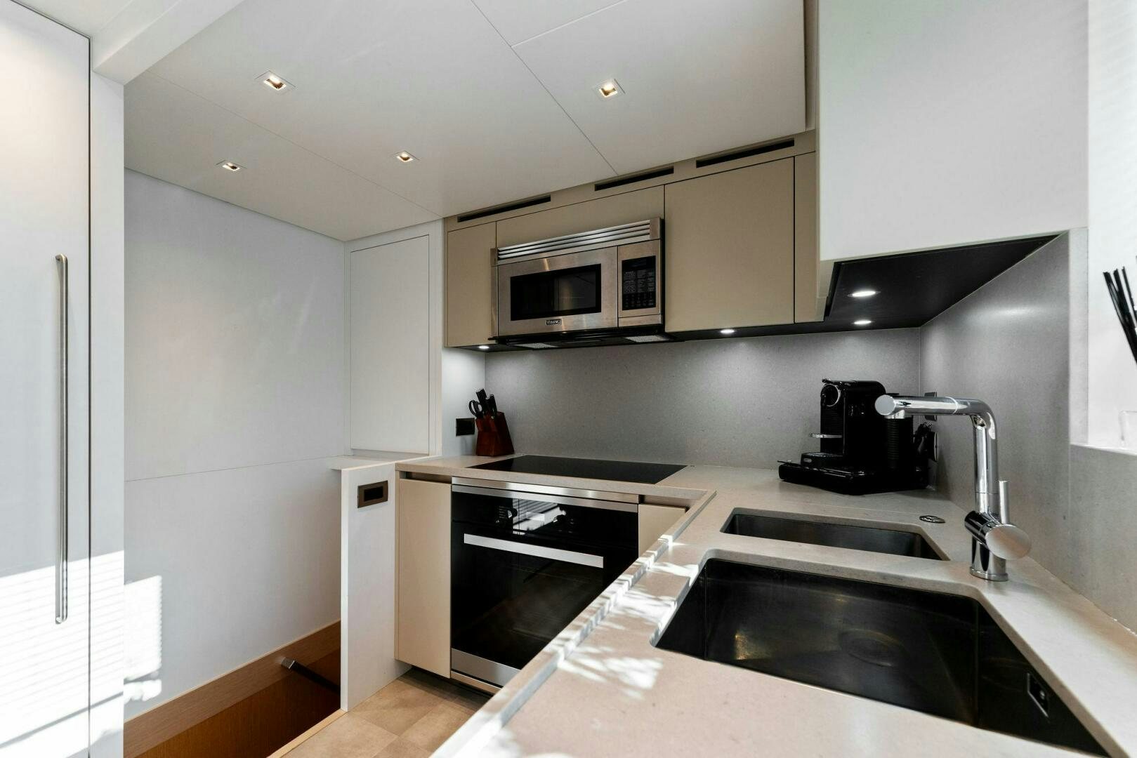 a kitchen with a sink and microwave aboard GATSBY Yacht for Sale