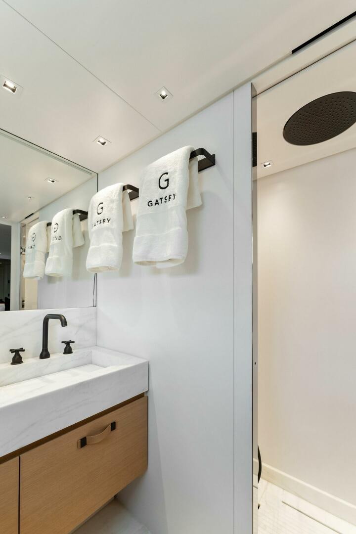 a bathroom with a sink and towels aboard GATSBY Yacht for Sale