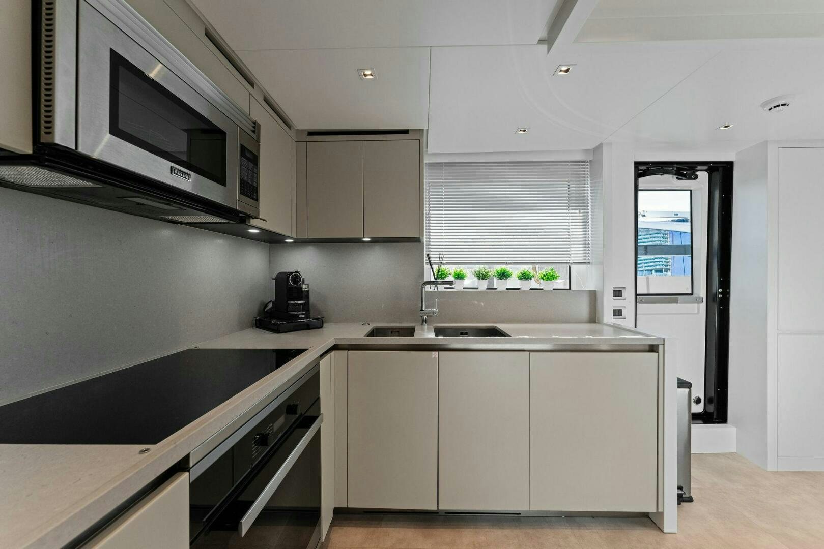 a kitchen with white cabinets aboard GATSBY Yacht for Sale
