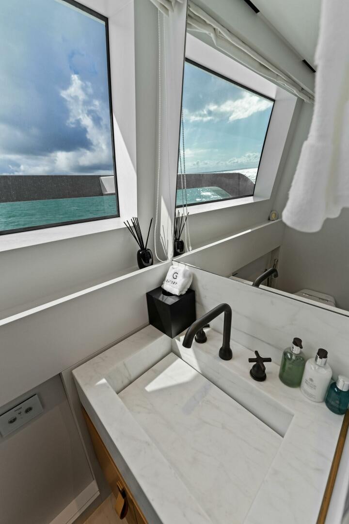 a bathroom with a large window aboard GATSBY Yacht for Sale