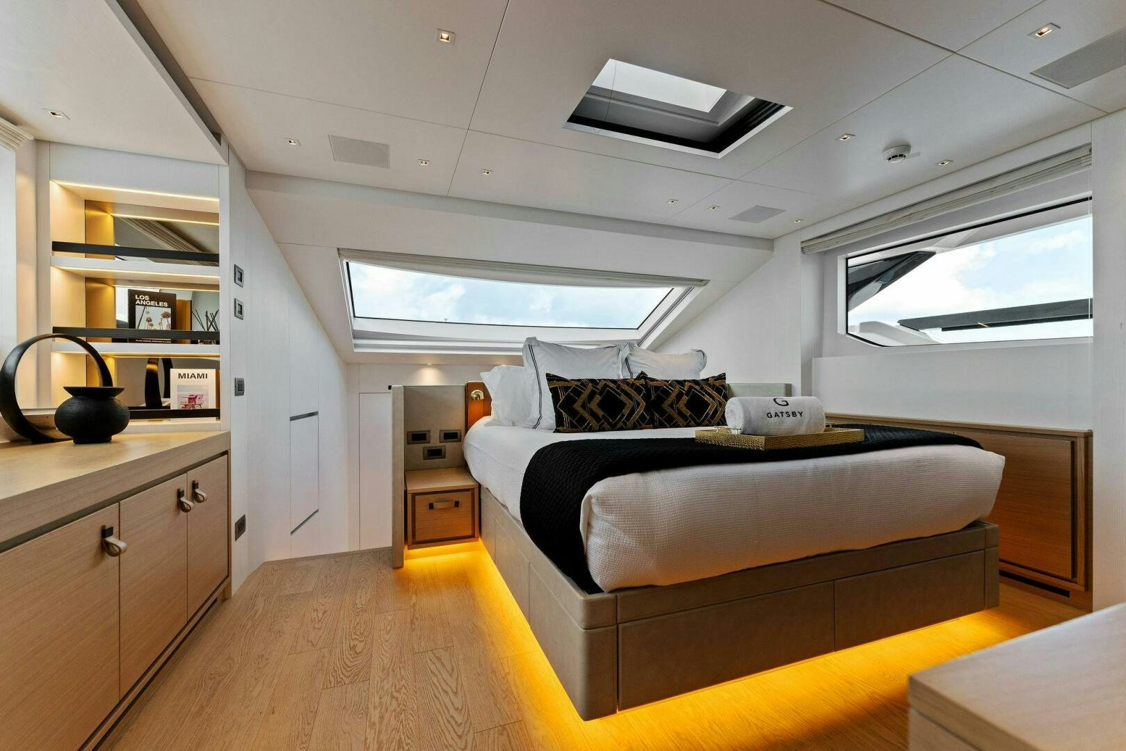 a bedroom with a bed and a desk aboard GATSBY Yacht for Sale