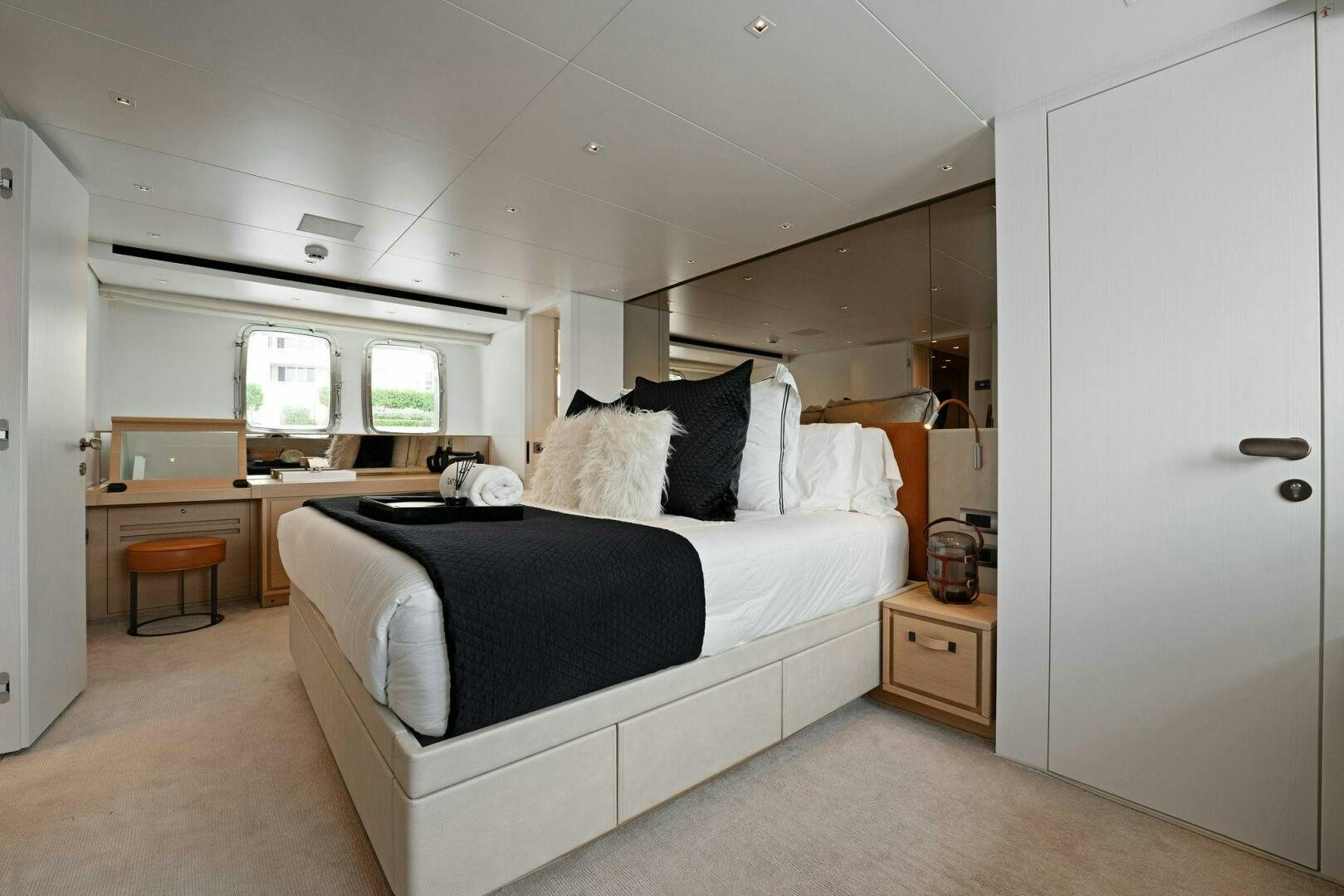 a bedroom with a bed and desk aboard GATSBY Yacht for Sale