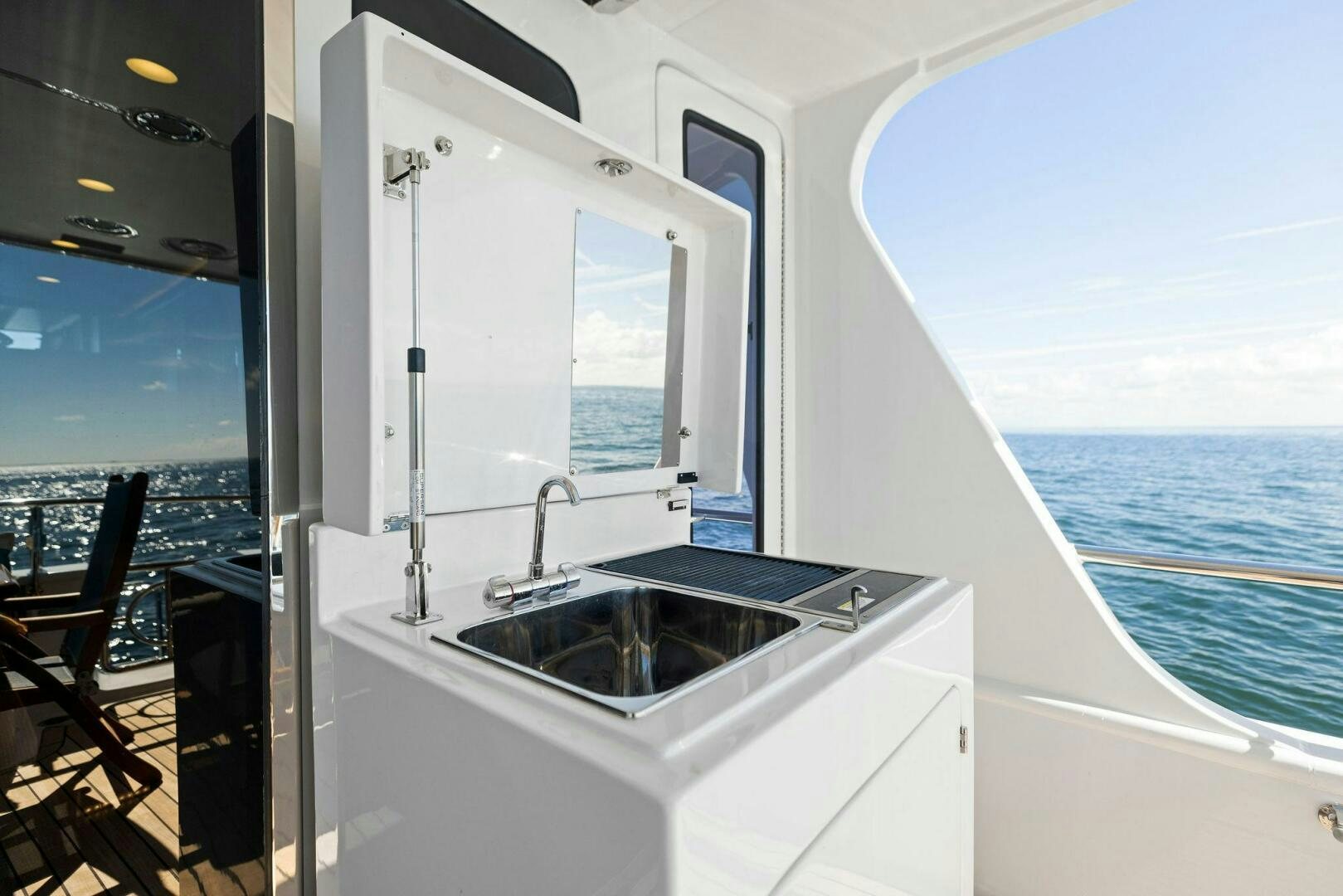 a bathroom with a large window overlooking the ocean aboard SUNZSET Yacht for Sale