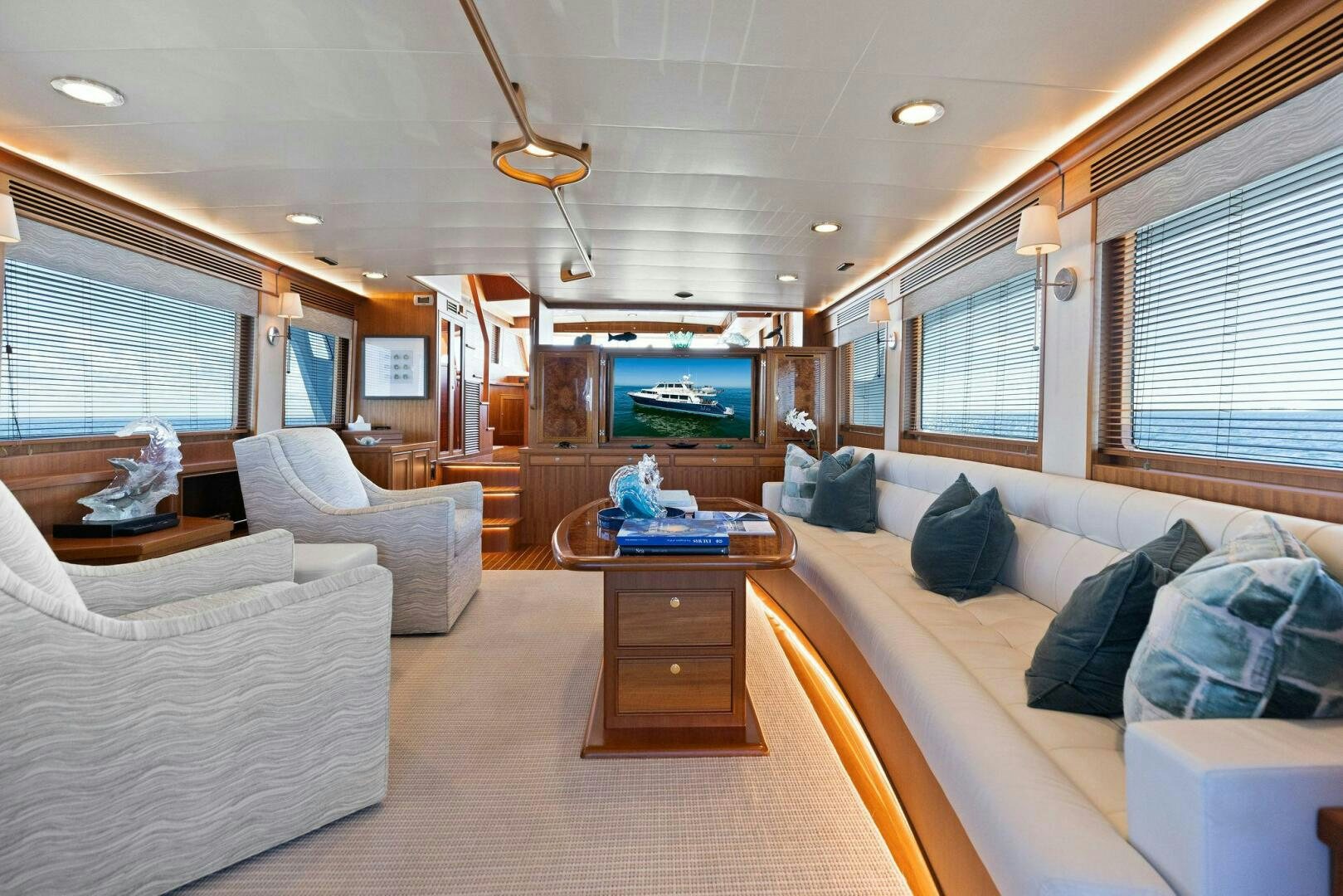 a living room with a large sofa and a tv aboard SUNZSET Yacht for Sale