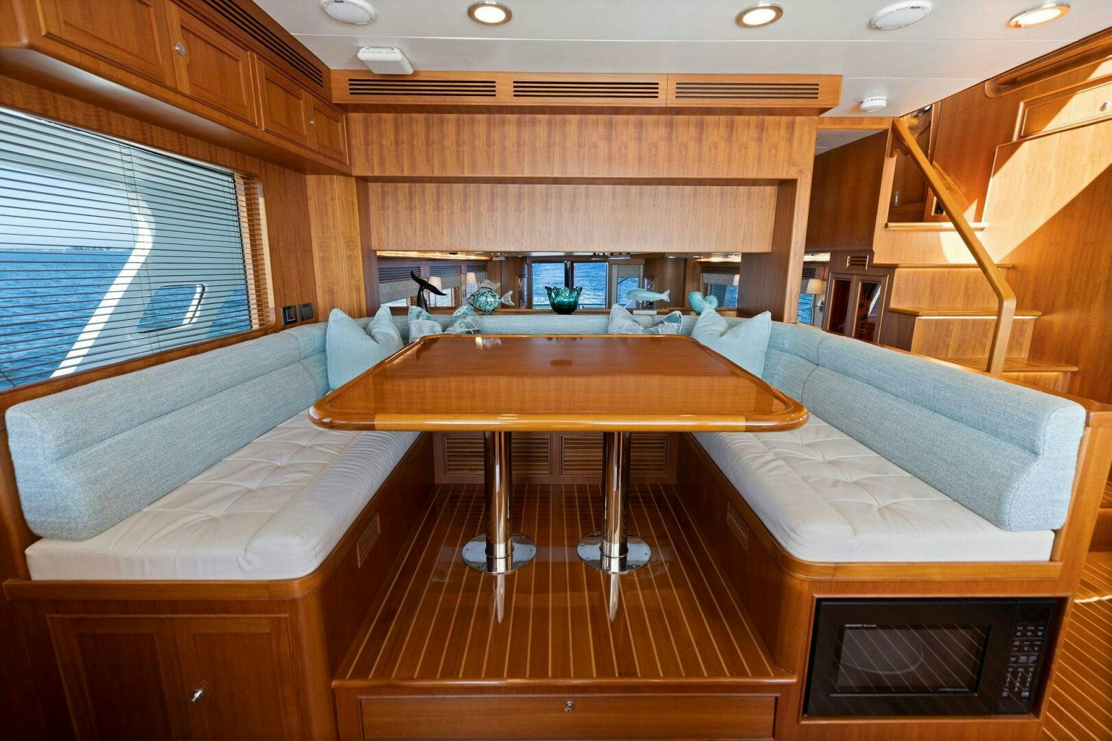 a room with a table and couches aboard SUNZSET Yacht for Sale