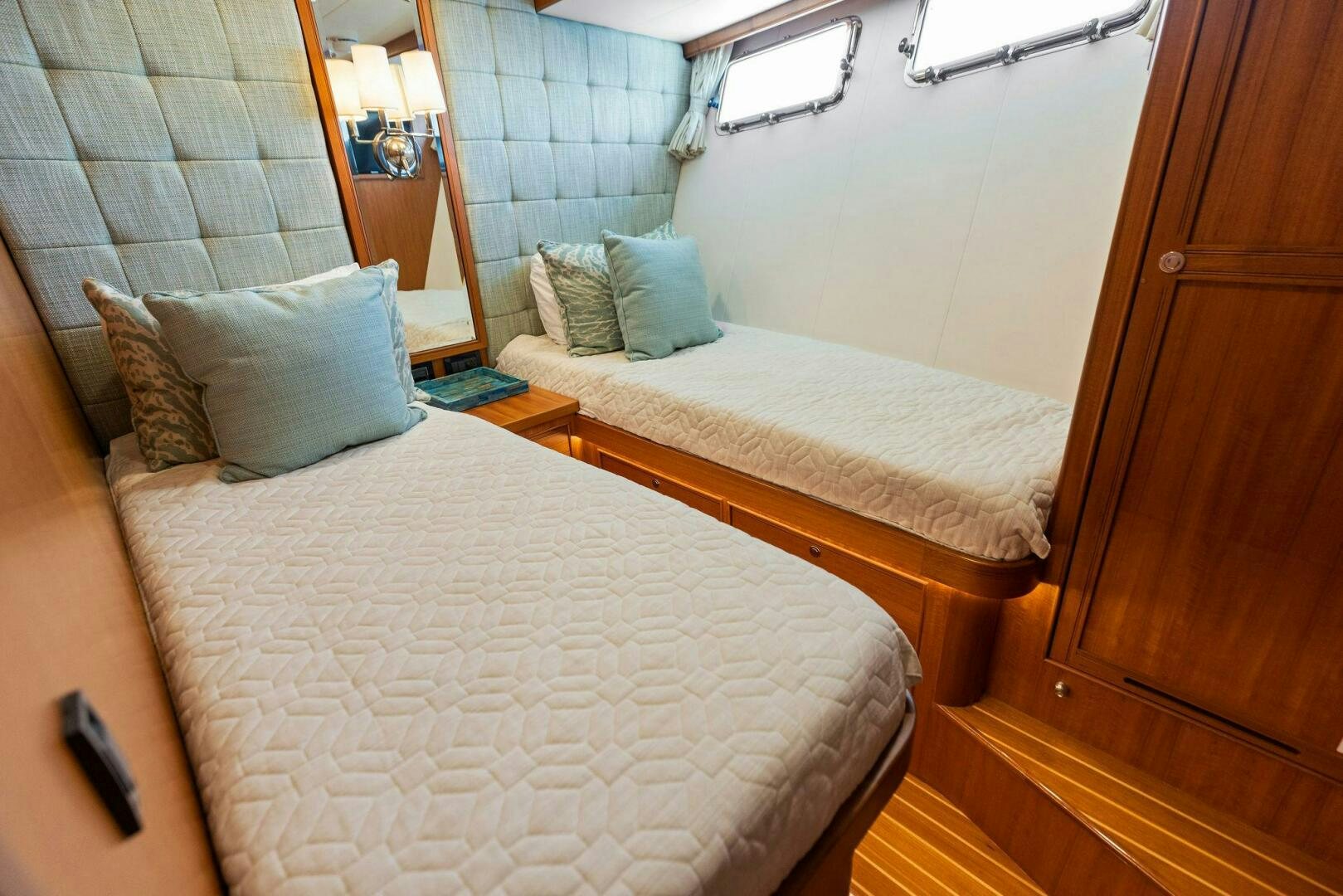 a bed with pillows and blankets aboard SUNZSET Yacht for Sale