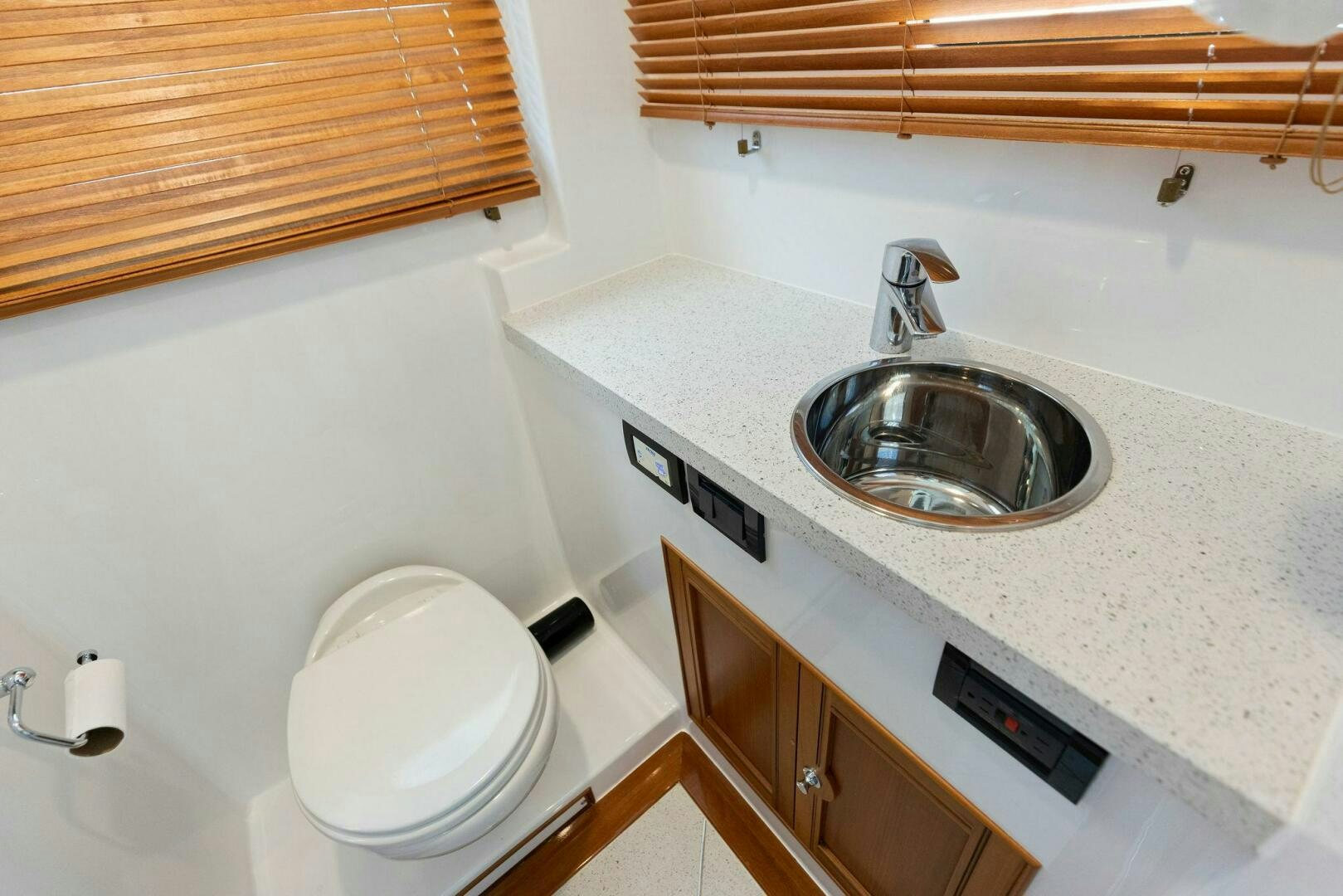 a bathroom with a sink and toilet aboard SUNZSET Yacht for Sale