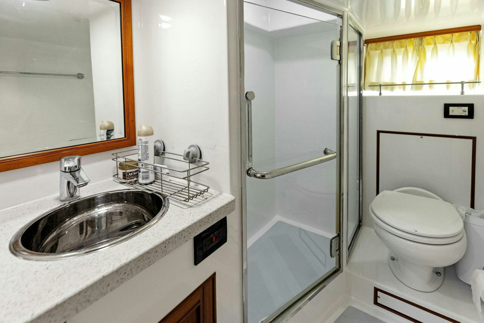 a bathroom with a sink toilet and a shower unit aboard SUNZSET Yacht for Sale