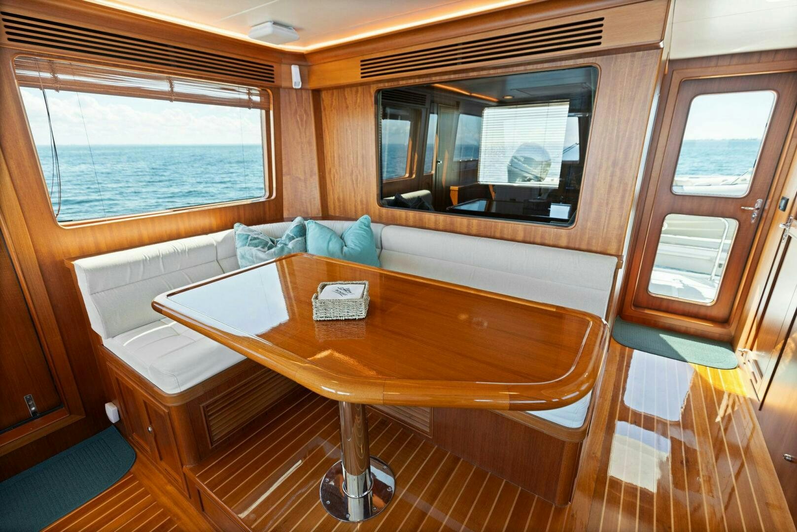 a table with a bench aboard SUNZSET Yacht for Sale