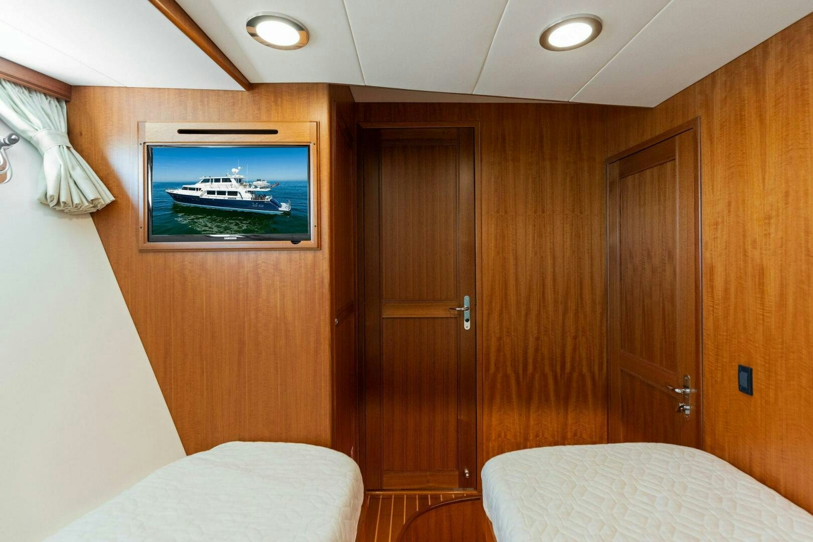 a room with a bed and a television aboard SUNZSET Yacht for Sale
