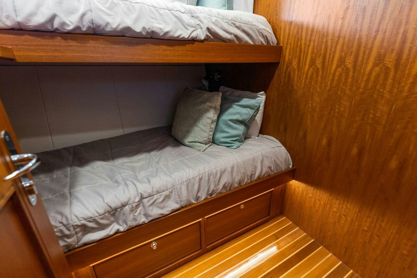 a bed with a blue comforter aboard SUNZSET Yacht for Sale