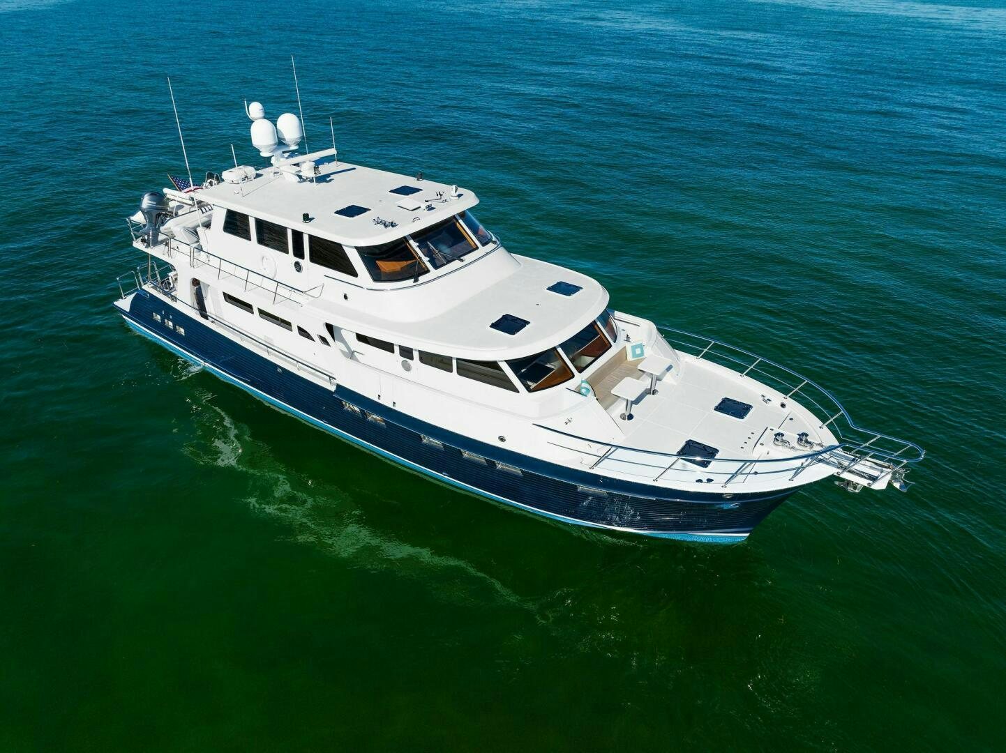 a large white boat in the water aboard SUNZSET Yacht for Sale
