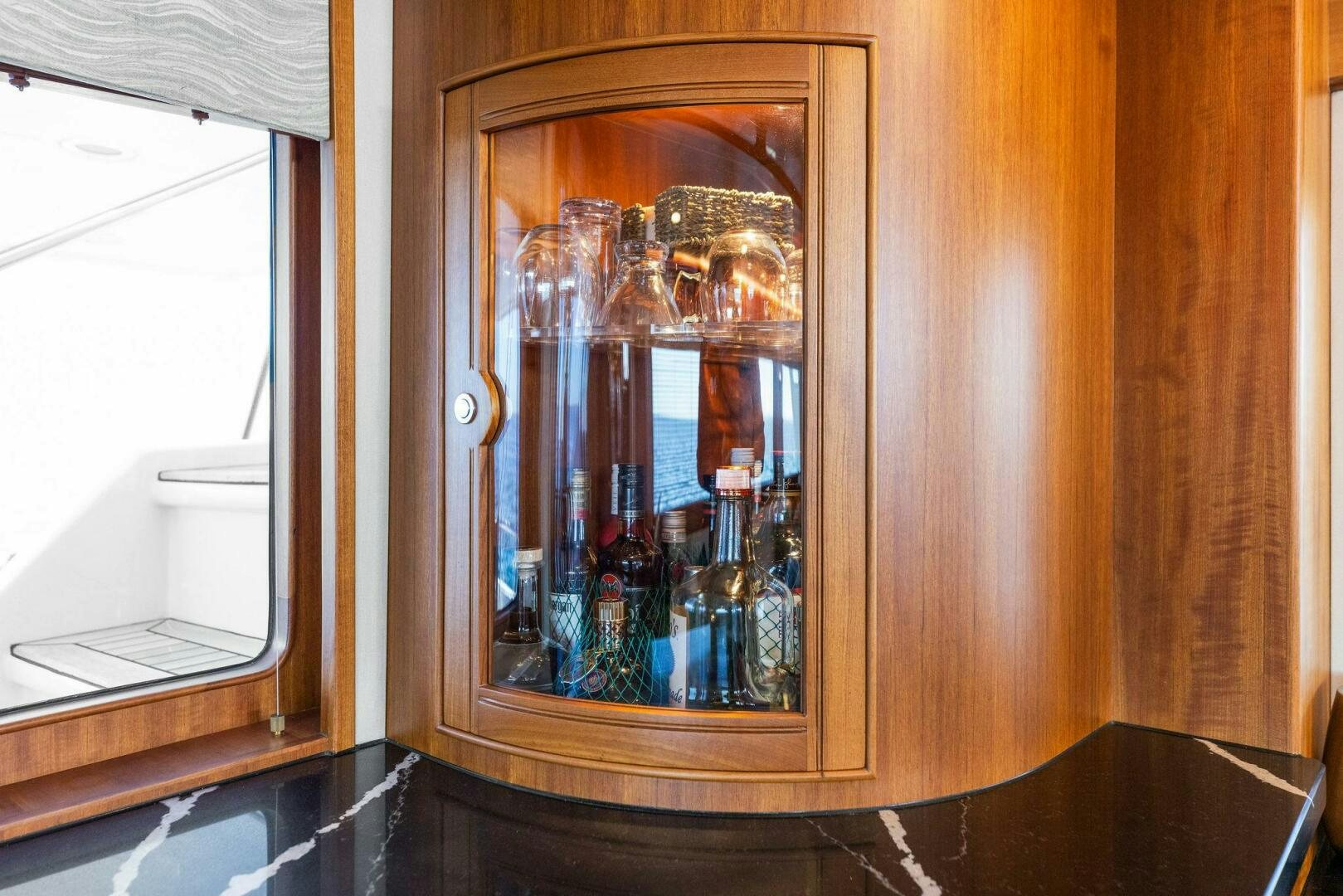 a glass cabinet with a glass door aboard SUNZSET Yacht for Sale