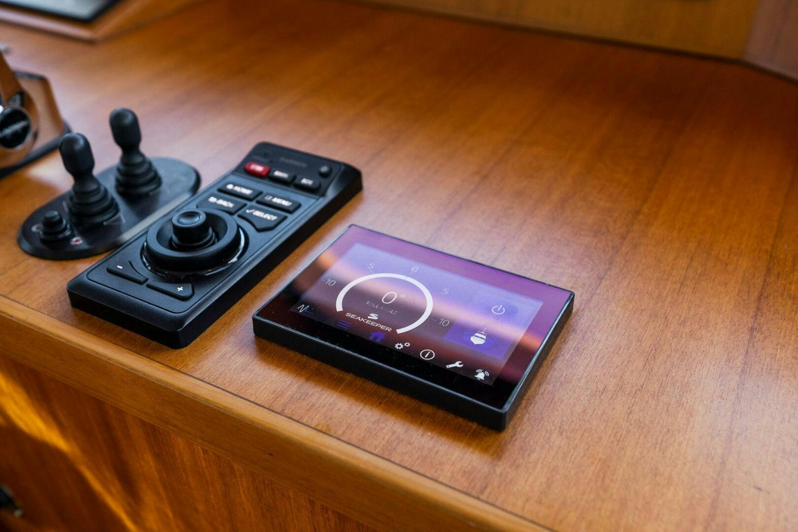 a black and silver telephone on a wood surface aboard SUNZSET Yacht for Sale