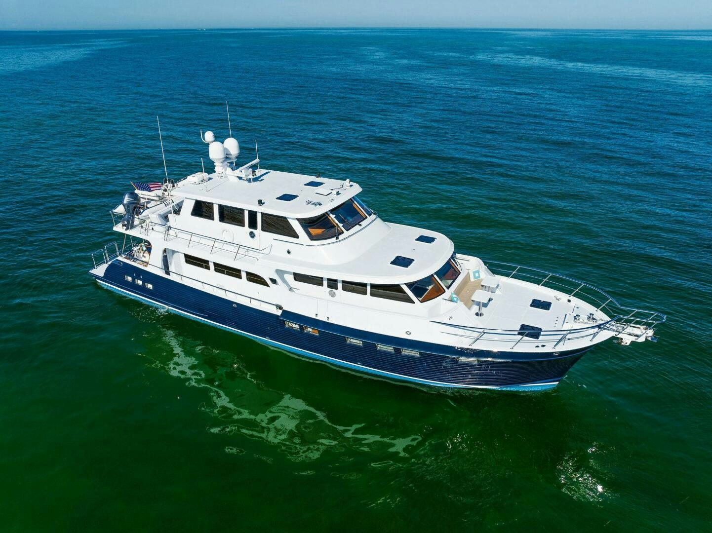 a large white boat in the water aboard SUNZSET Yacht for Sale